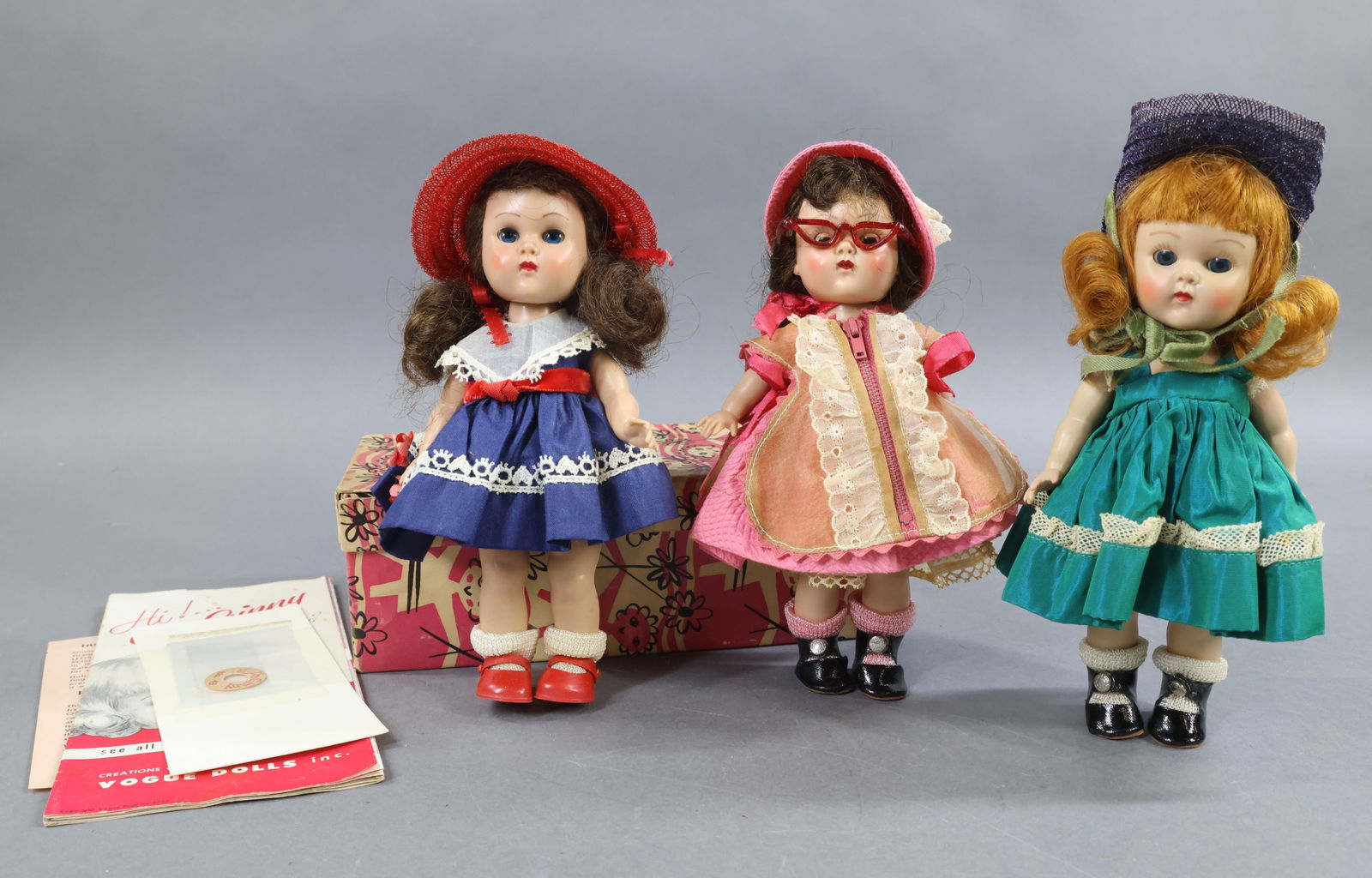 1940's-1960's DOLLS.: LOT of (3) 8" 1954 VOGUE "Ginny" painted lash walking dolls. (1) In an OB, #43 "Tiny Miss", comes with instruction sheet for Walking Ginny in box. Brown pigtails. Tagged clothing. Paper wrist tag No.