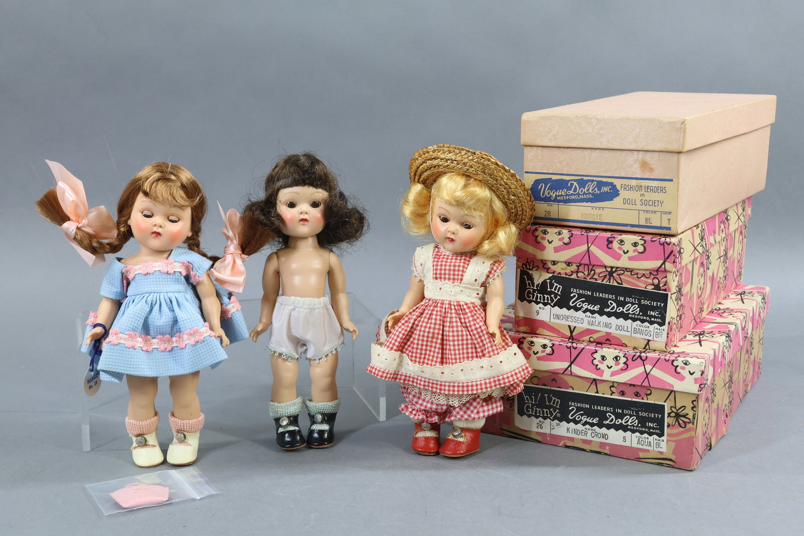 1940's-1960's DOLLS.: LOT of (3) 8" VOGUE "Ginny" painted lash dolls in an OB. Doll 1) is a strung doll. She has a blonde flip. Dressed in original unmarked clothing with straw hat. Red oilcloth center snap shoes. Box end