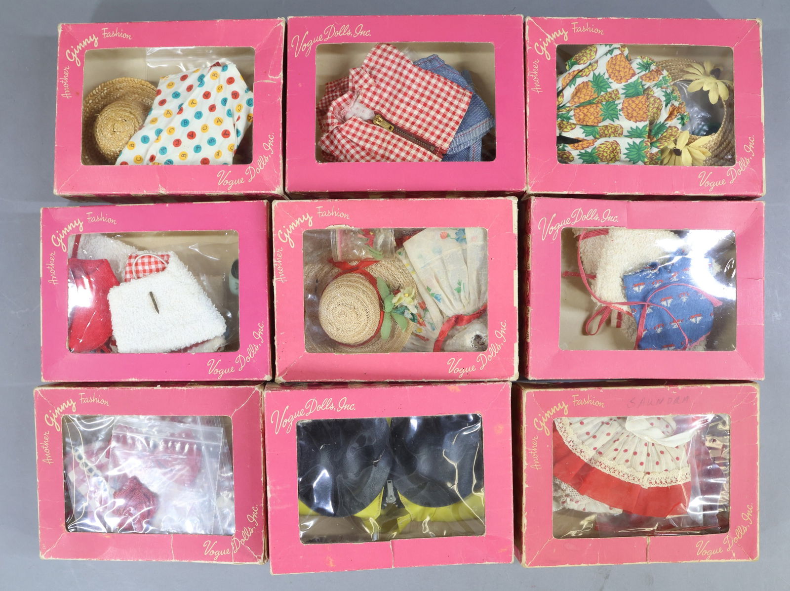 1940's-1960's DOLL ACCESSORIES.: LOT of (9) boxes of VOGUE "Ginny" outfits. 1952-1953, 1954-1956. All of them are tagged except for the Talon Zipper Raincoat set. Condition: some boxes have additional or duplicate pcs. Some have 1