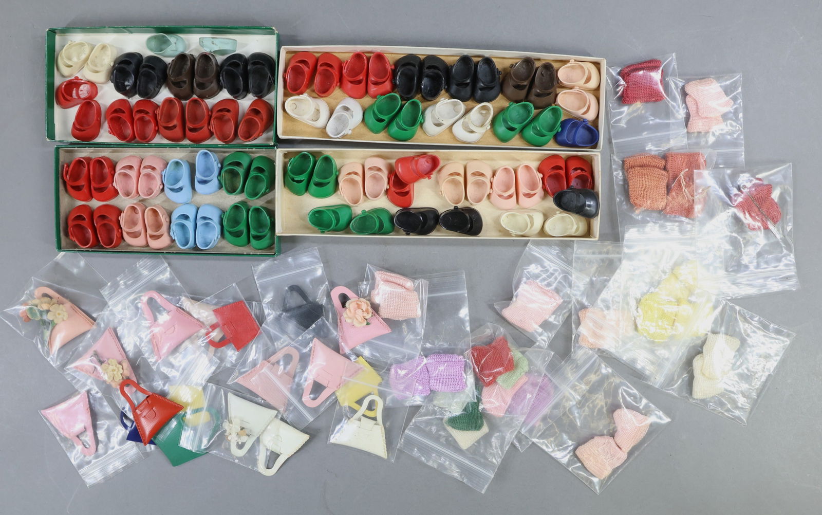 1940's-1960's DOLL ACCESSORIES.: LOT of items for 1950's-60's VOGUE "Ginny" and other 8" dolls. (34) Prs. of vinyl shoes. (Some singles.) (14) Prs. of various colored rayon socks. (Some singles.) (17) Unmarked vinyl handbags. This