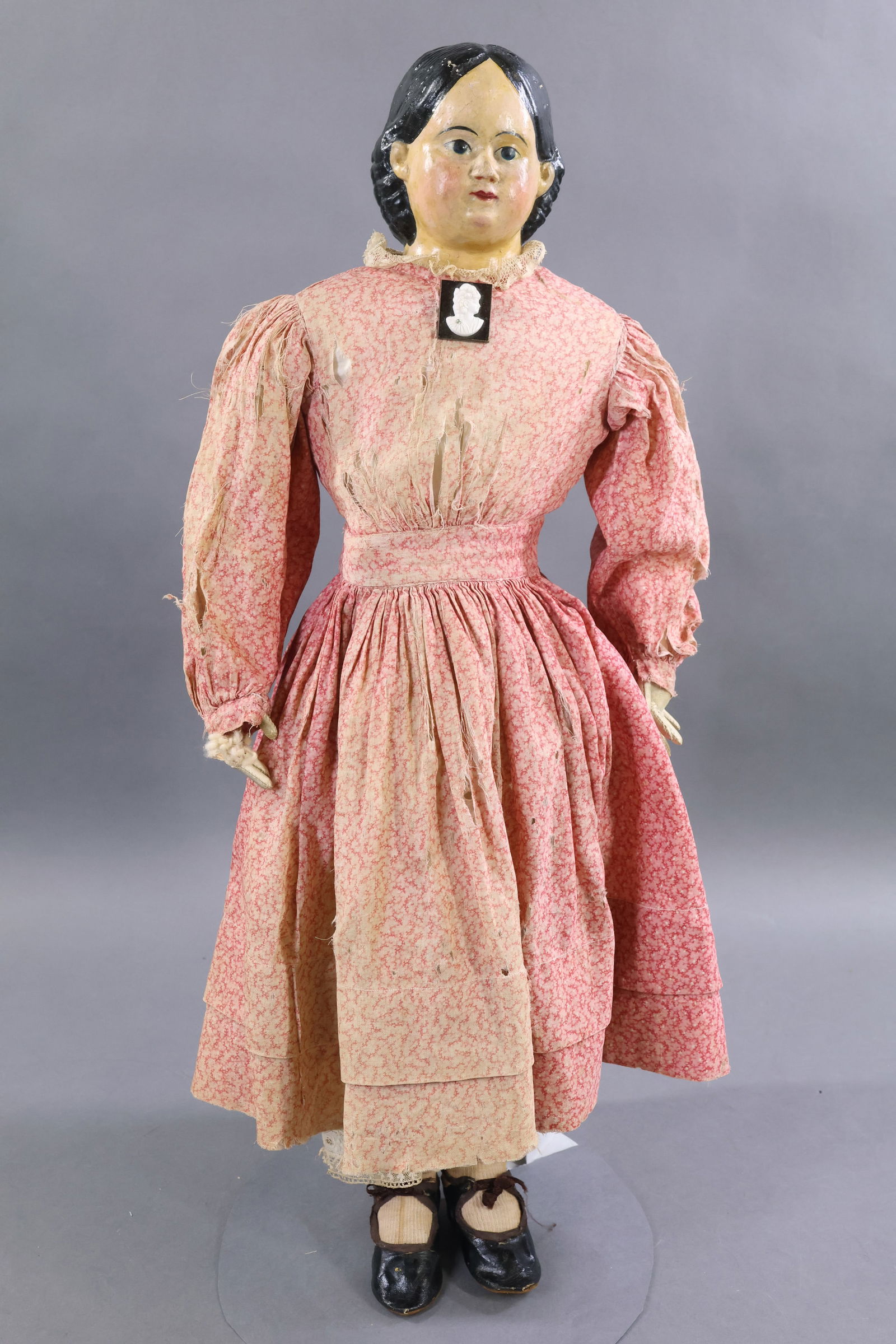 PAPIER MACHE DOLLS.: 25" LUDWIG GREINER Pat'd March '58. Label on back of shoulder plate. Painted black hair, blue eyes. Original cloth body with white leather lower arms, individual fingers. Dressed in antique cotton