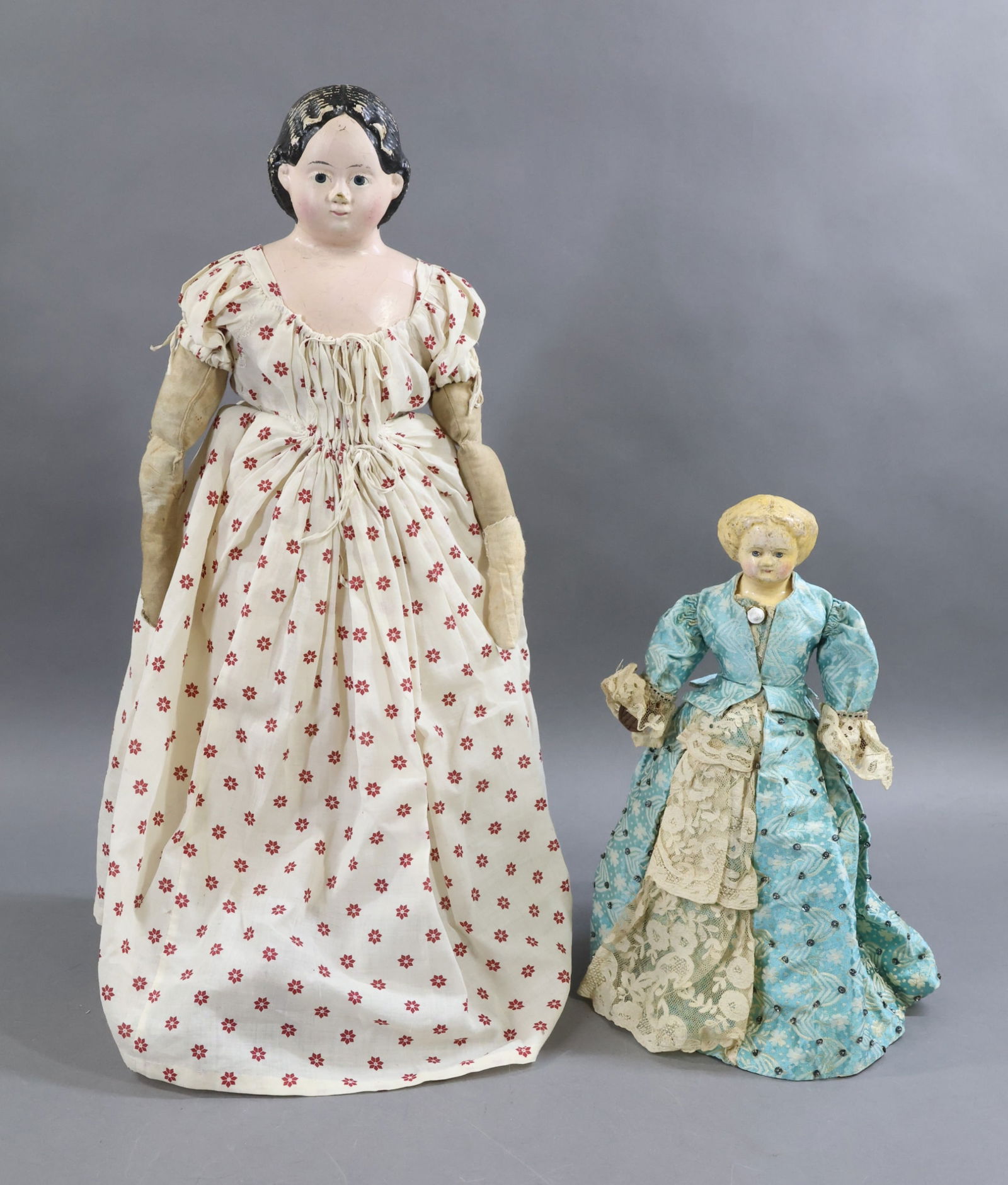 PAPIER MACHE DOLLS.: Pair of dolls. 21" LUDWIG GREINER Pat'd March '58. Label on back of shoulder plate. Painted black hair, blue eyes. Antique cloth body with mitt hands. Dressed in antique cotton print dress.