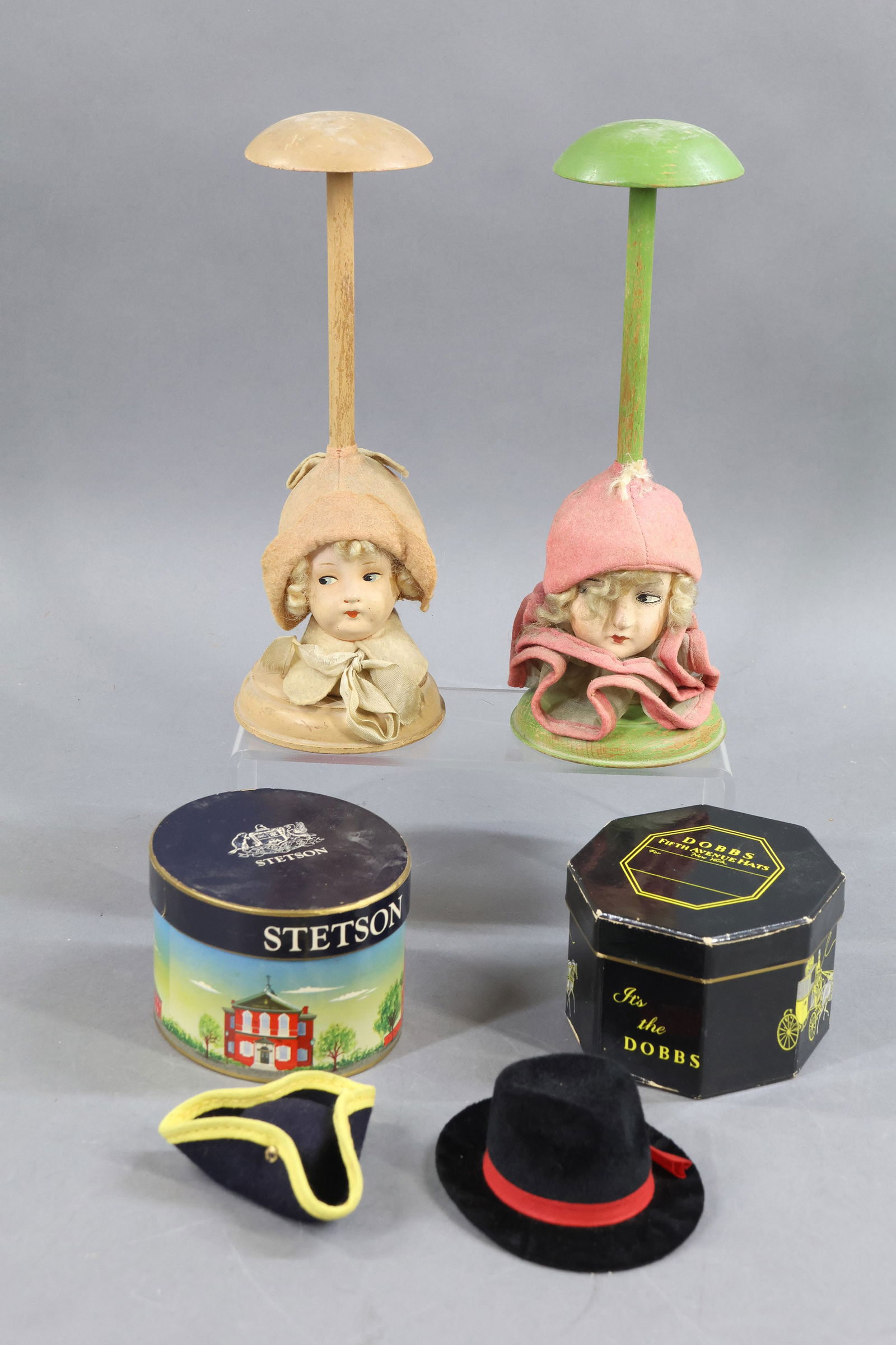 HOLIDAY/NOVELTIES.: NOVELTY. Pair of antique (1930's) 9 1/2" hat stands with papier mache ladies' heads. Both have mohair wigs. Pair of sample men's hat boxes with a hat inside. DOBBS of Fifth Avenue and STETSON. (Hats