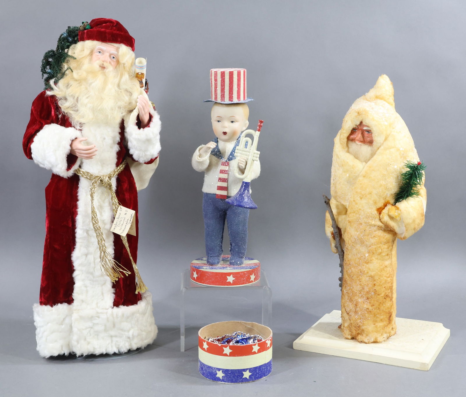 HOLIDAY/NOVELTIES.: HOLIDAY. CHRISTMAS. Pair of artist Santas. 19" 1980 "Father Christmas" with his bag of toys, by artist Rosemarie Snyder, Wildwood, NJ. Porcelain face, hands, lower legs. Stand. 14" Unmarked Santa in