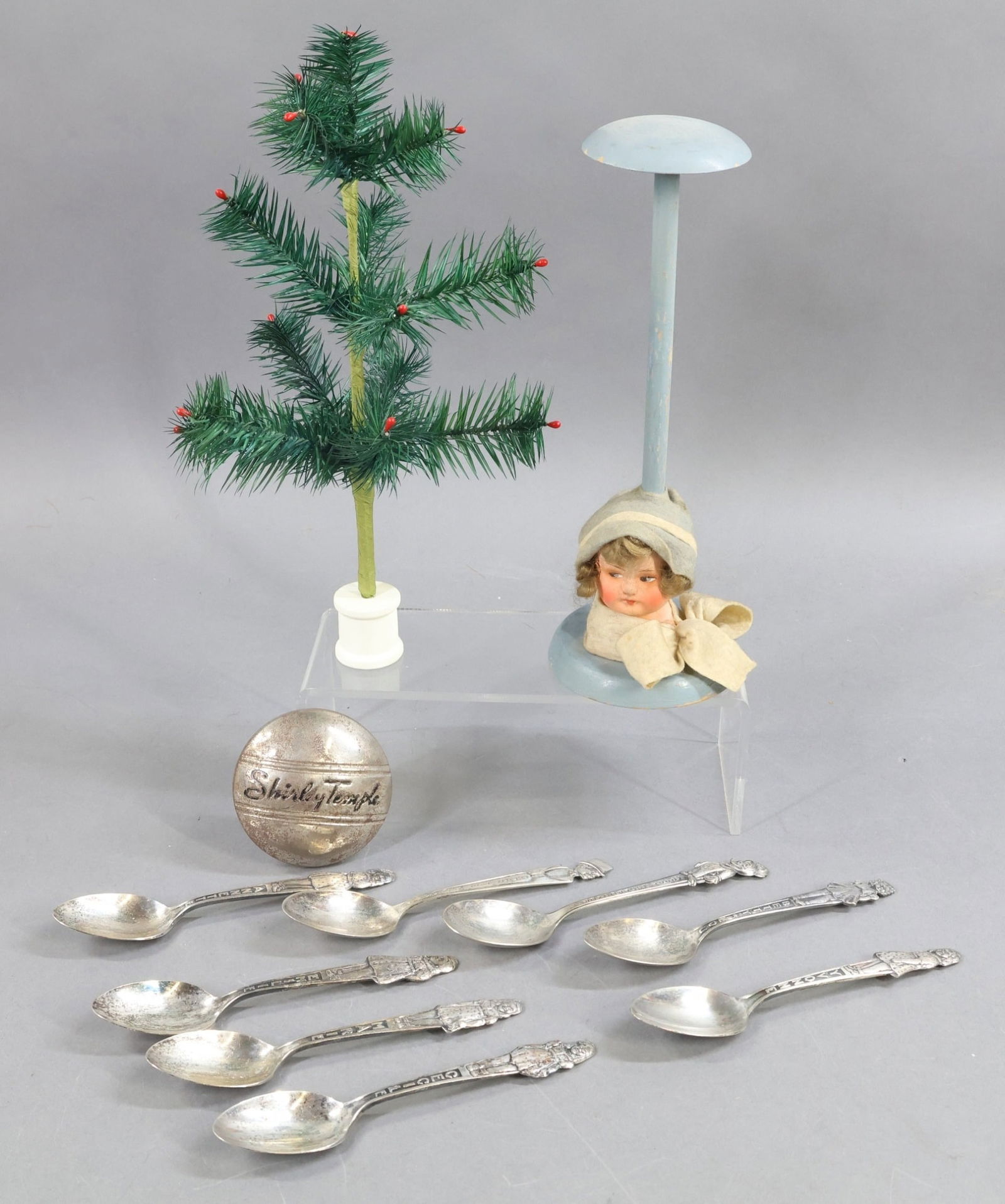 HOLIDAY/NOVELTIES.: HOLIDAY & NOVELTY. Holiday - 11" Chicken feather Christmas tree. Novelty - 9 1/2" (1930's) hat stand with papier mache ladies' head, mohair wig. Lot of Novelty silverplate spoons - "Charlie
