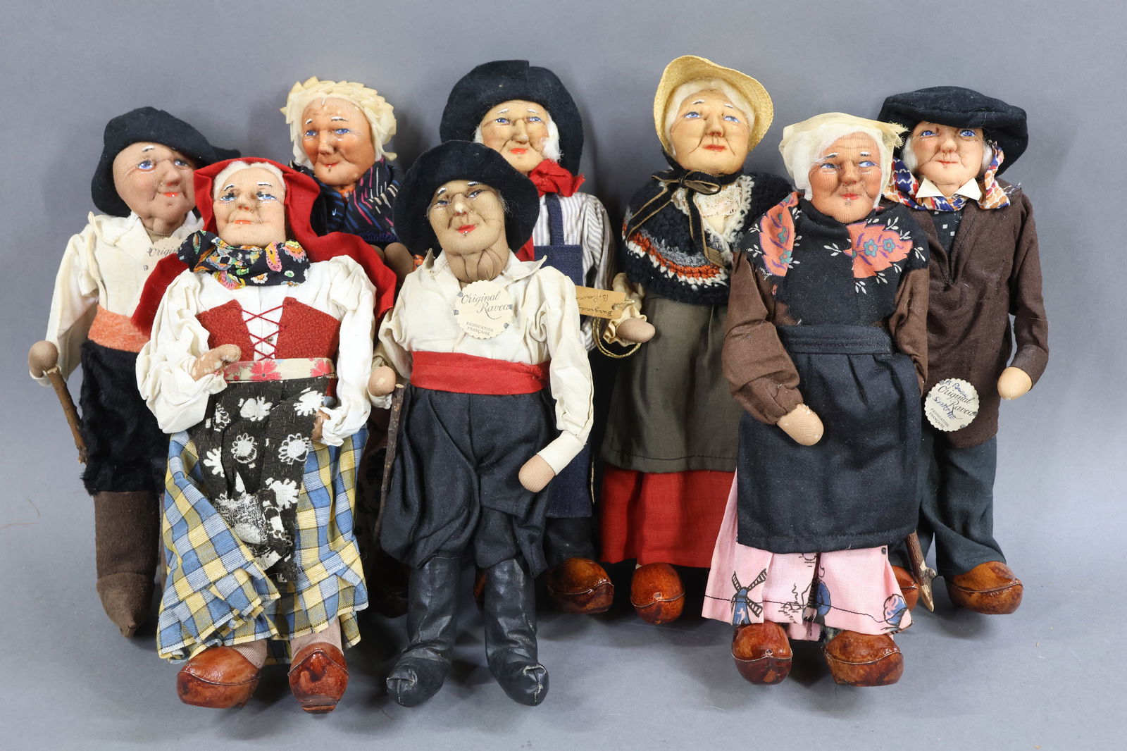 RAVCA.: LOT of (8) 9"-10" Elderly Bernard Ravca dolls. All are marked Made in France or have the RAVCA medallions. (4) Males and (4) females. All of the dolls are either wearing clogs or boots. Condition: min