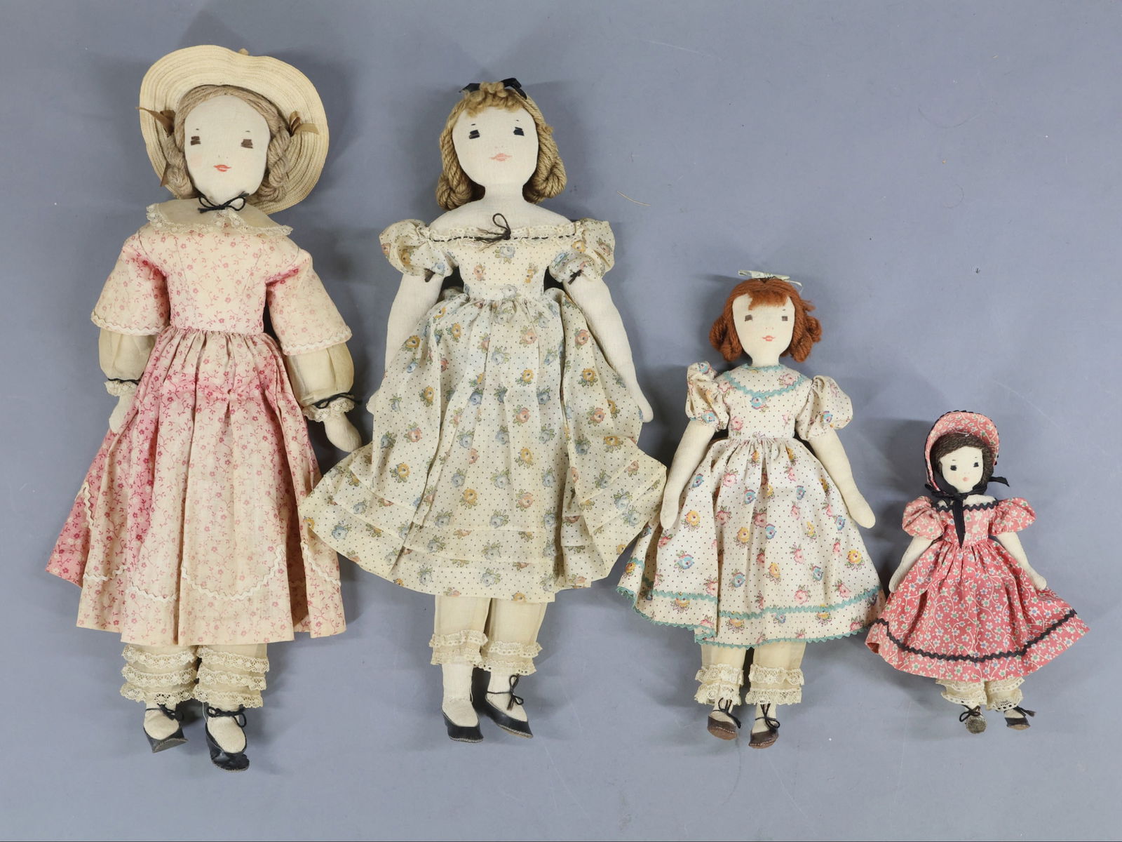 CLOTH DOLLS.: LOT of (4) 1940's all original Edith Flack Ackley muslin dolls. This appears to be a family of girls. 15 1/2", 15", 10 1/2", 7". All of them have embroidered features, interesting wool yarn hair