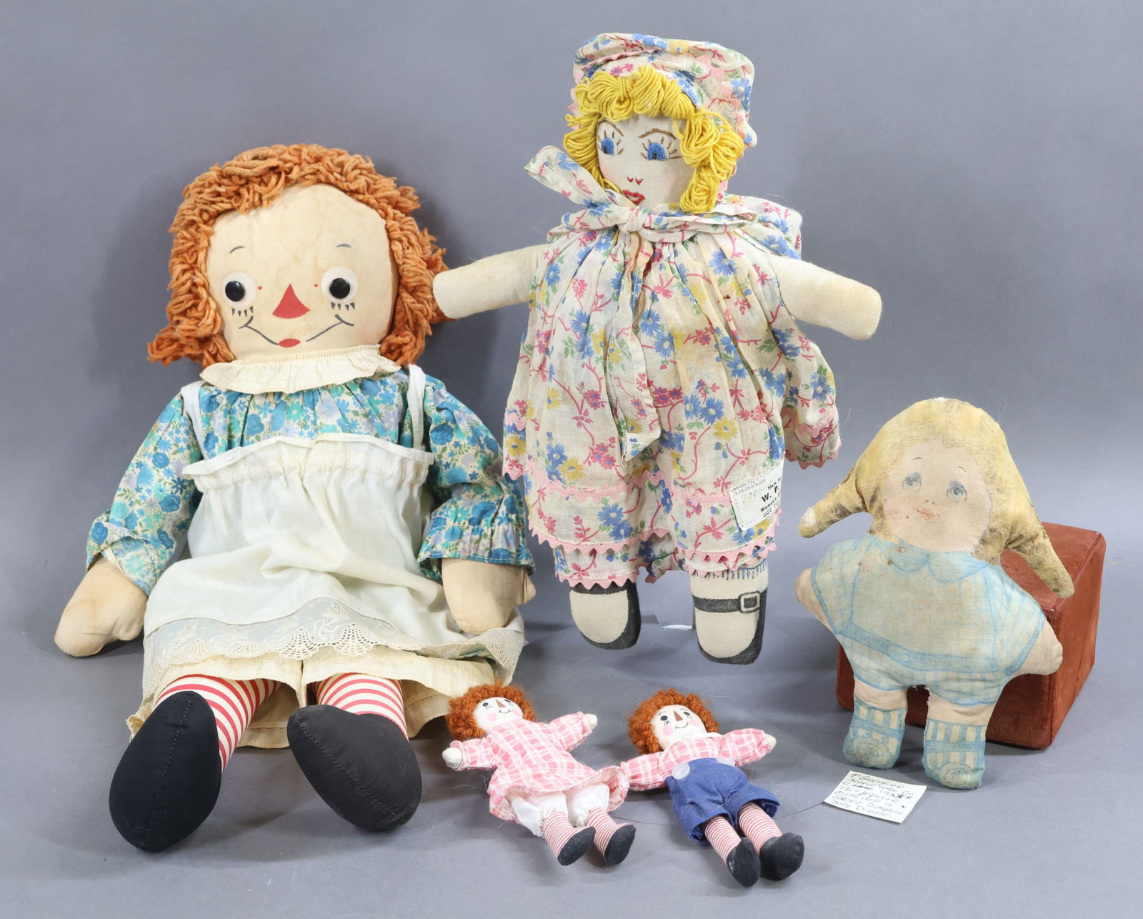 CLOTH DOLLS.: LOT of AMERICAN dolls. 12" All original tagged 1938 "WPA" doll with embroidered features. Stand. Condition: age discoloration. 20" Tagged Georgene Novelties "Raggedy Ann" doll. All original clothing e
