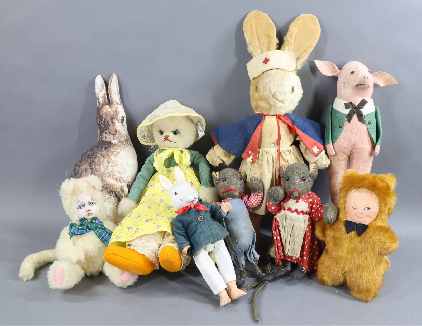 NOVELTY ANIMAL DOLLS.: LOT. 16" Tagged CHARACTER white mohair/cloth dressed CAT doll. 12" Unmarked German pink wool felt PIG doll with squeaker (still in working order. ). (Age discoloration.) 19" Unmarked white plush