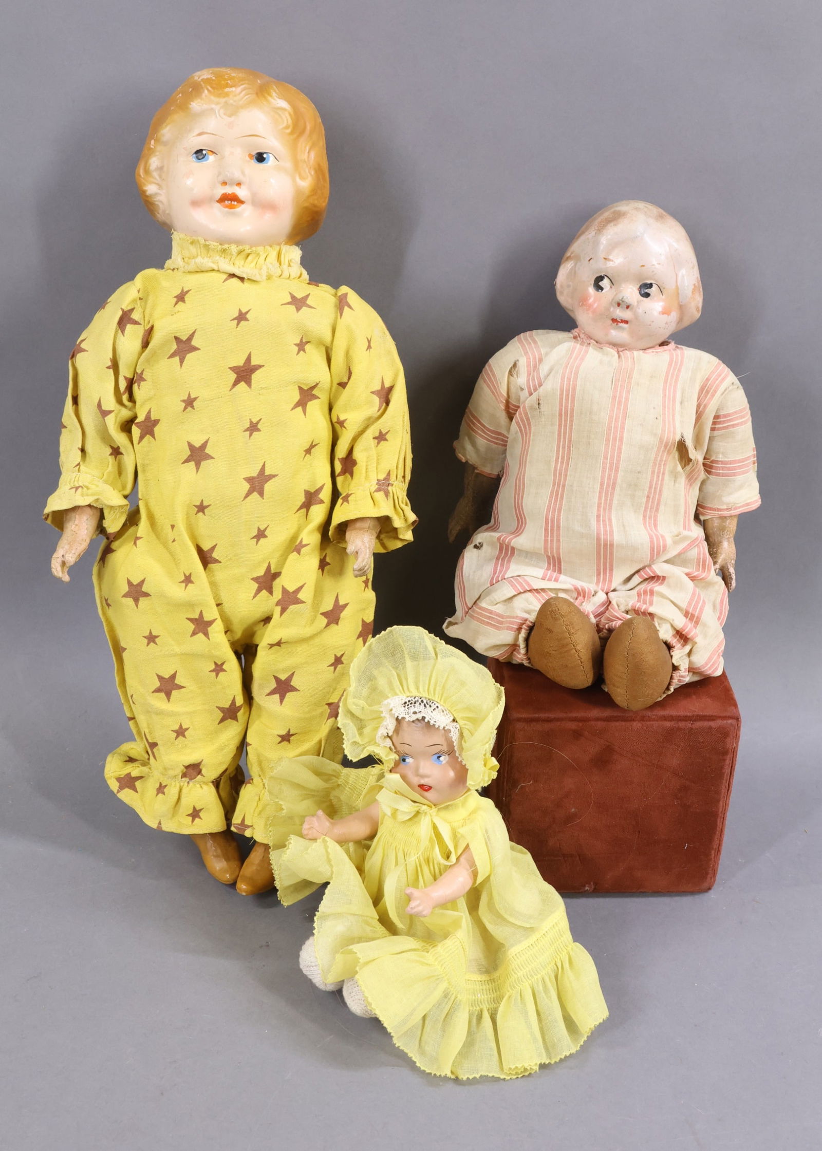 COMPOSITION DOLLS.: LOT of (3) dolls. All of them are unmarked and have painted features, hair. All are dressed in original or antique clothing. Doll 1) 7" (Dionne type) Baby with blue eyes, brown hair. 5 Pc. bent limb b