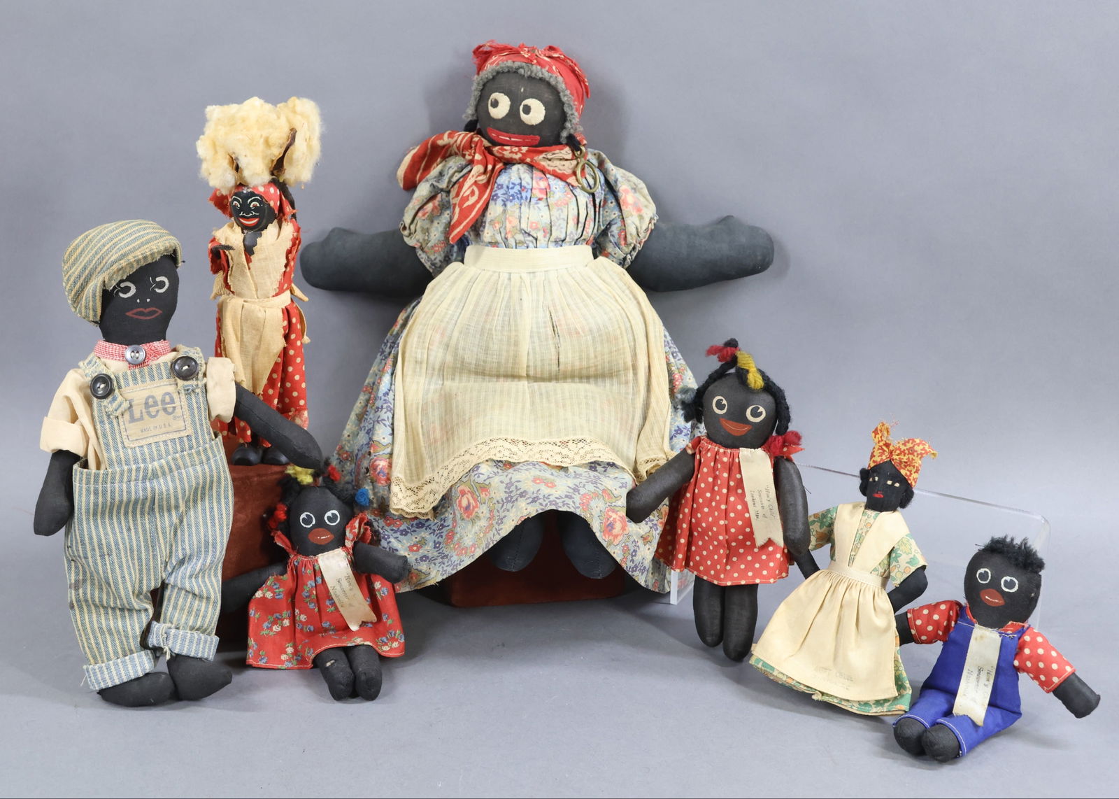 BLACK DOLLS.: LOT of handmade cloth rag dolls that appear to have been made for the tourist market. Many are marked. (3) 6" - 7" Child dolls with painted features have wool hair. They have ribbons that read: