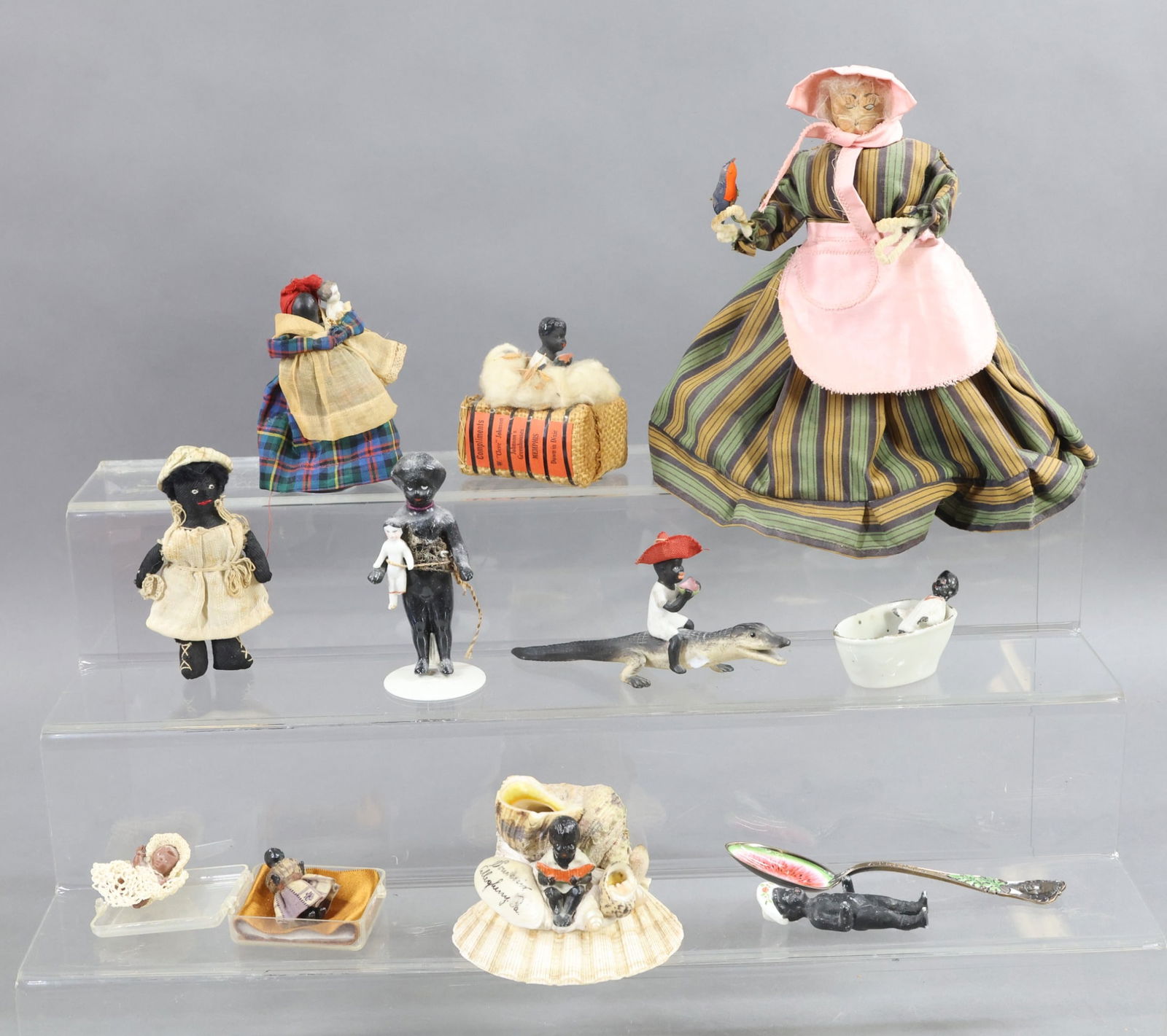 BLACK DOLLS/FIGURINES.: LOT. Dolls - Frozen Charlies, dressed, undressed, molded hat (damage). Cloth. Nipple Mammy holding Frozen Charlie. Boy on alligator (damage). Souvenir dolls/figurines from Memphis and Allegheny, PA.