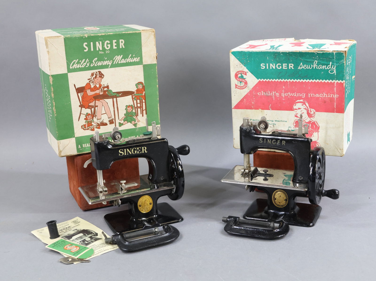 NOVELTY TOYS.: Pair of SINGER No. 20 Child's Sewing Machines in OB. These toy machines are nearly identical but (1) box reads: Made in USA and the other Made in Great Britain. Both machines are marked with the word