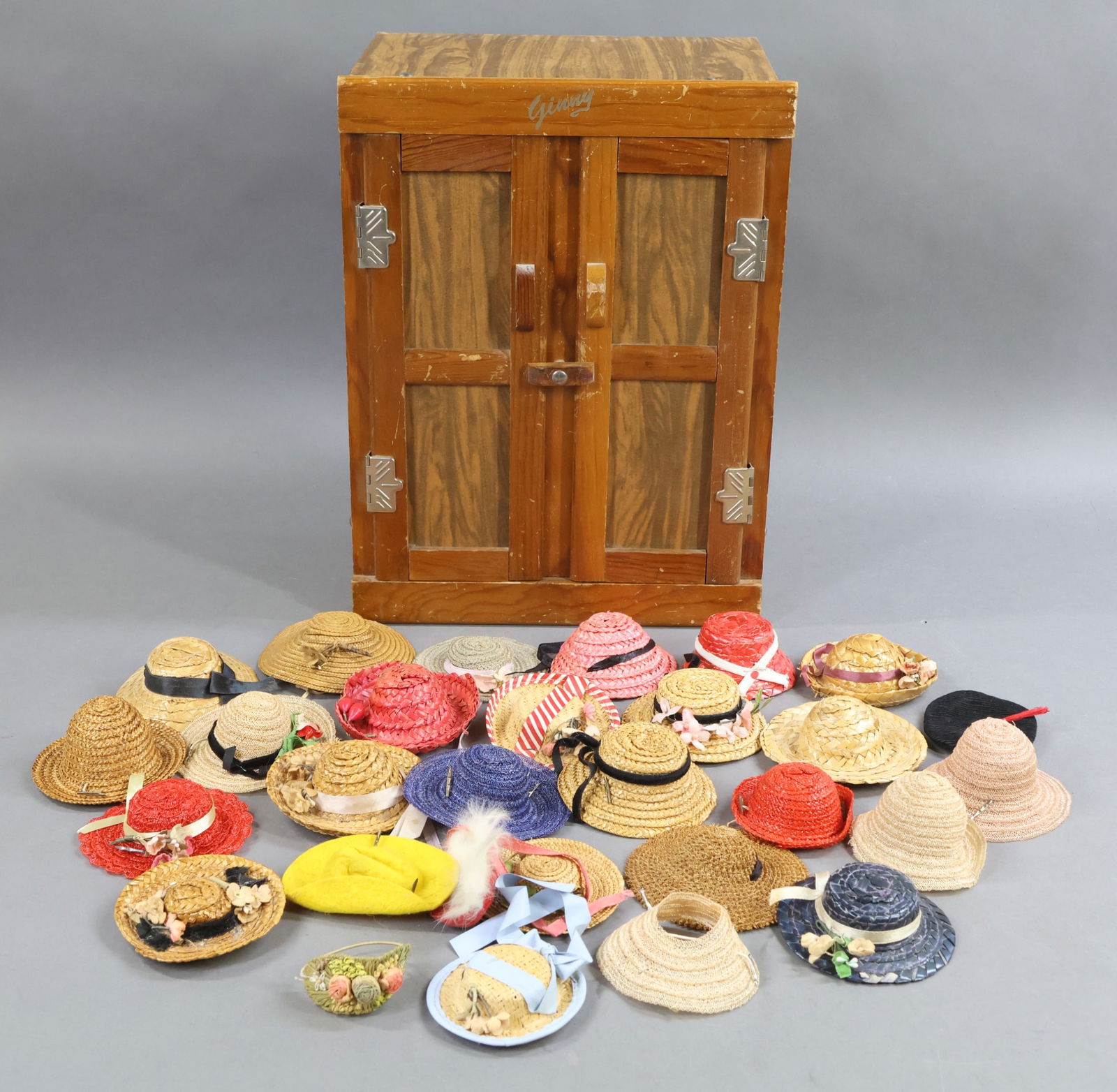 1940's-1960's DOLL ACCESSORIES.: LOT. (25+) Hats for 8" VOGUE Ginny and other 8" dolls. Felt, straw, woven, others. Also - GINNY Wardrobe, cardboard and wood. 14" x 10 1/2" x 6 1/2". This lot is being sold AS IS.