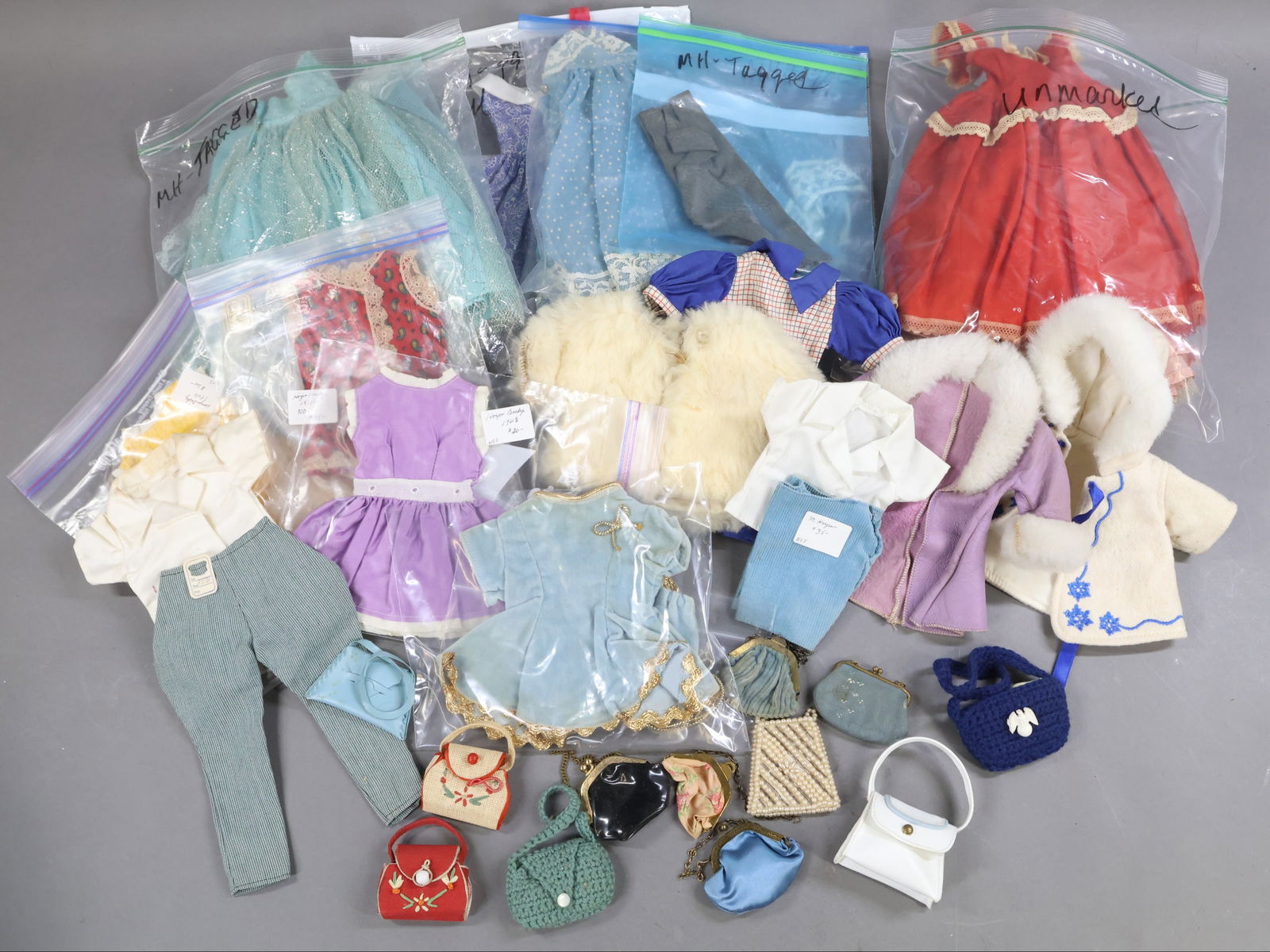 1950's-1960's DOLL ACCESSORIES.: LOT of MARY HOYER clothing. Tagged - strapless gown with wrap and petticoat. Strapless gown. Long pants. Tagged Playdoll - cotton print dress. Unmarked - short dresses, pant/shirt combos, coats.