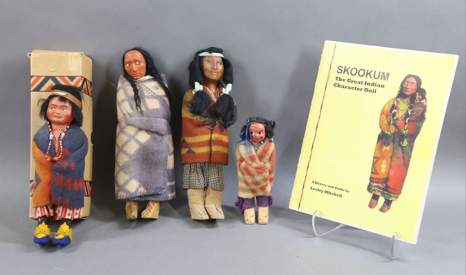 NATIVE AMERICAN DOLLS.: LOT of (4) all original SKOOKUM /type dolls. All of these dolls have mohair wigs. None have any markings on their soles. (2) Children - 7" SKOOKUM/type? with felt moccasins. 10" 1930's doll in an