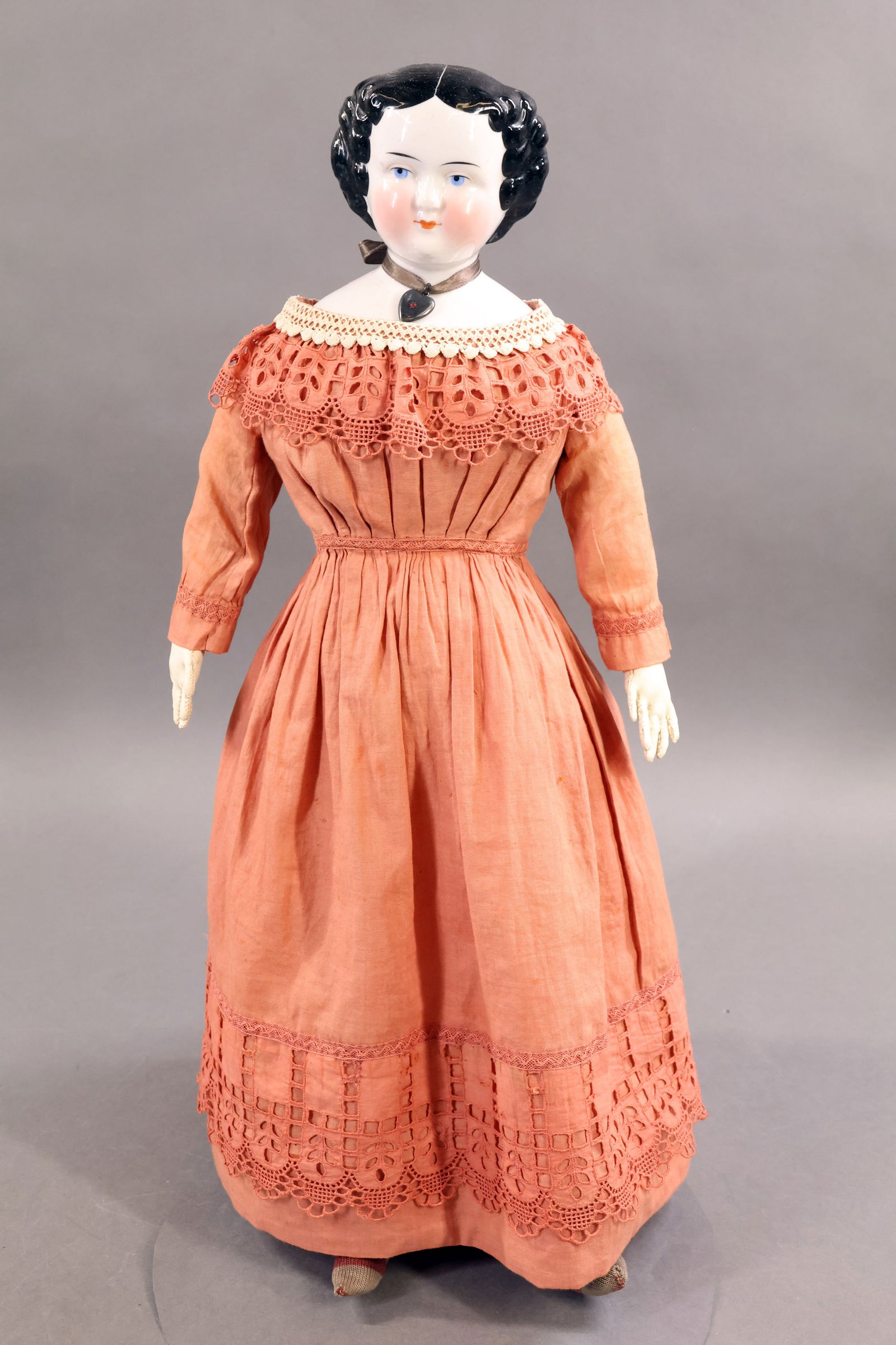CHINA DOLLS.: 20" Unmarked doll with black flat top style hair, center part. Blue eyes, rosey cheeks. Cloth body with white leather arms, individual fingers. Dressed in all antique cotton clothing - dark pink