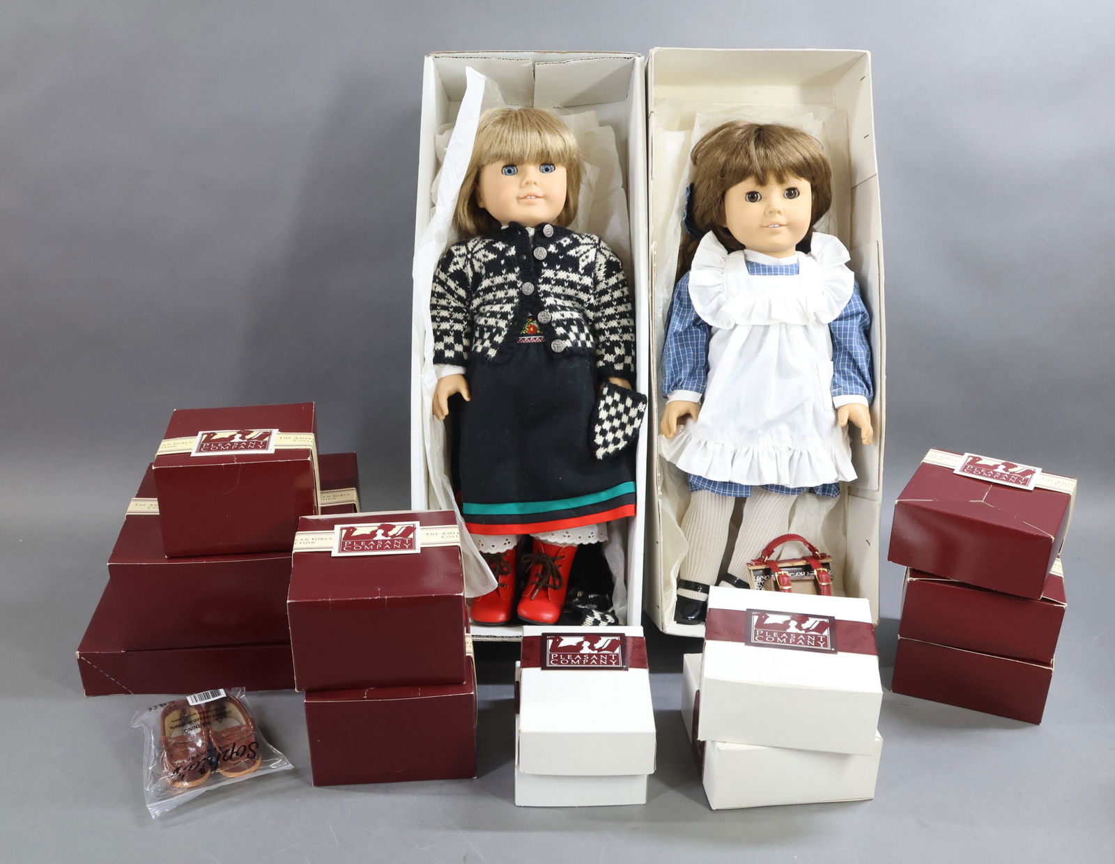 AMERICAN GIRLS.: LOT. (2) Dolls in OB. Pleasant Company "Samantha" in her Play Dress/Pinafore. She is carrying her Book Strap and Supplies. "Kirsten" in her Winter Skirt, Blouse, Snowshoes, knit woolens. Condition: