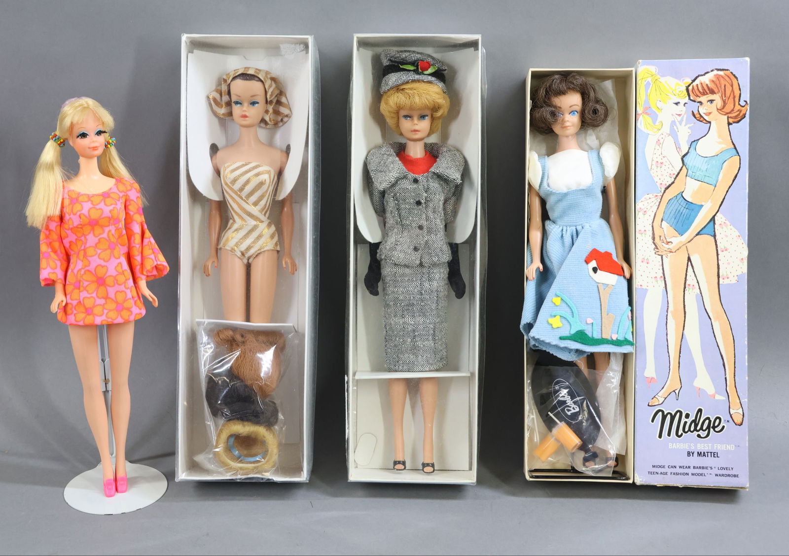 VINTAGE BARBIE/FAMILY.: LOT of (4) dolls. All of the dolls are dressed in original clothing. MIDGE doll in OB. Box end reads: No. 860 Brunette. Doll has a wire stand. (Age loss on box.) No boxes - Blonde "Bubble Cut" BARBIE
