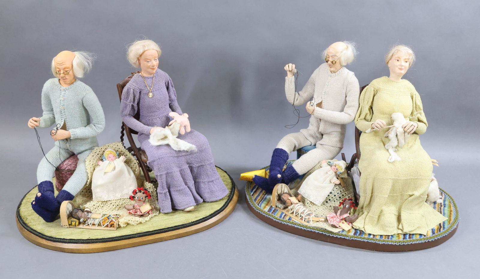 ARTIST DOLLS.: Pair of scenic items on bases, both by artist Laura Alleman. Both bases are 18" x 13", both are approx. 14" T. Both dated 1977, "Christmas Priorities". Both are Scenes of Grandparents - She is in a