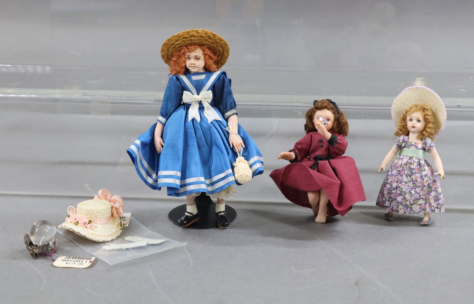 MINIATURE DOLL ARTIST DOLLS.: LOT. Doll in blue silk Sailor Style dress by artist Marcia Backstoms. Signed on leg MB96 1714. Stand. Doll in lavender floral dress and garden party hat by artist Anabda E. Skinner. Doll in burgundy