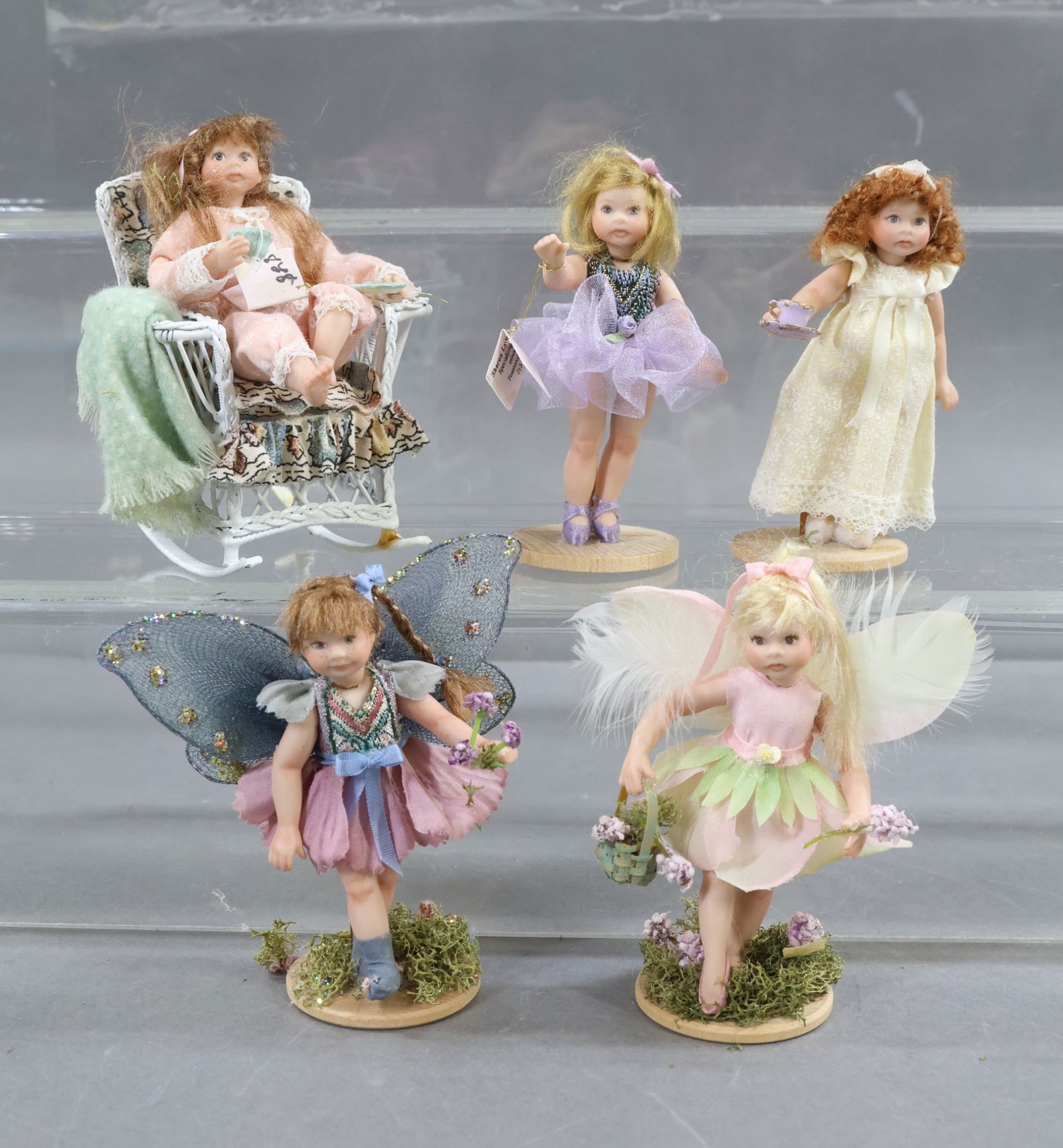 MINIATURE DOLL ARTIST DOLLS.: LOT of (5) porcelain doll miniatures by artist Sharon Lynn Spindler. "Flower Fairy". "Purple Ballerina". "Pink Fairy". "Pajama Girl with Tea Cup". Rocking Chair with cushion. "Girl in Nightgown with