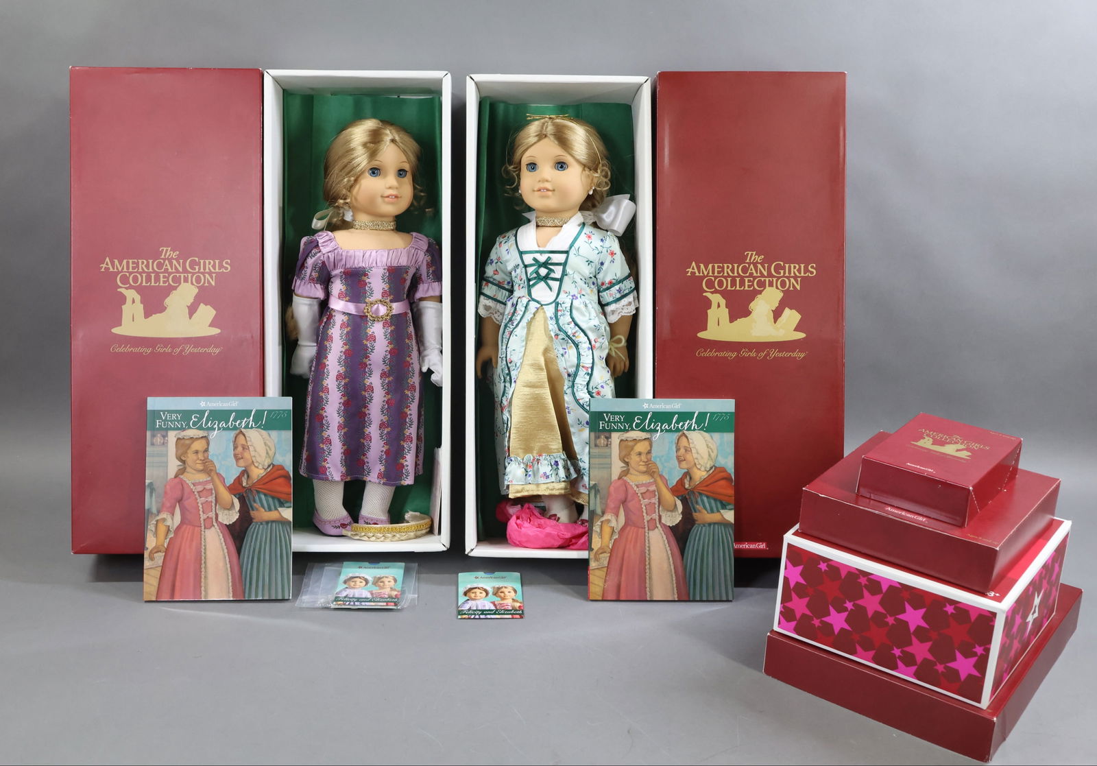 AMERICAN GIRLS.: LOT of ELIZABETH. (2) Dolls in OB w/books, wearing different outfits. Comes with wardrobe of different outfits. Elizabeth's Doll. Tea For Two Set. Condition: outfits may not be complete. This lot is