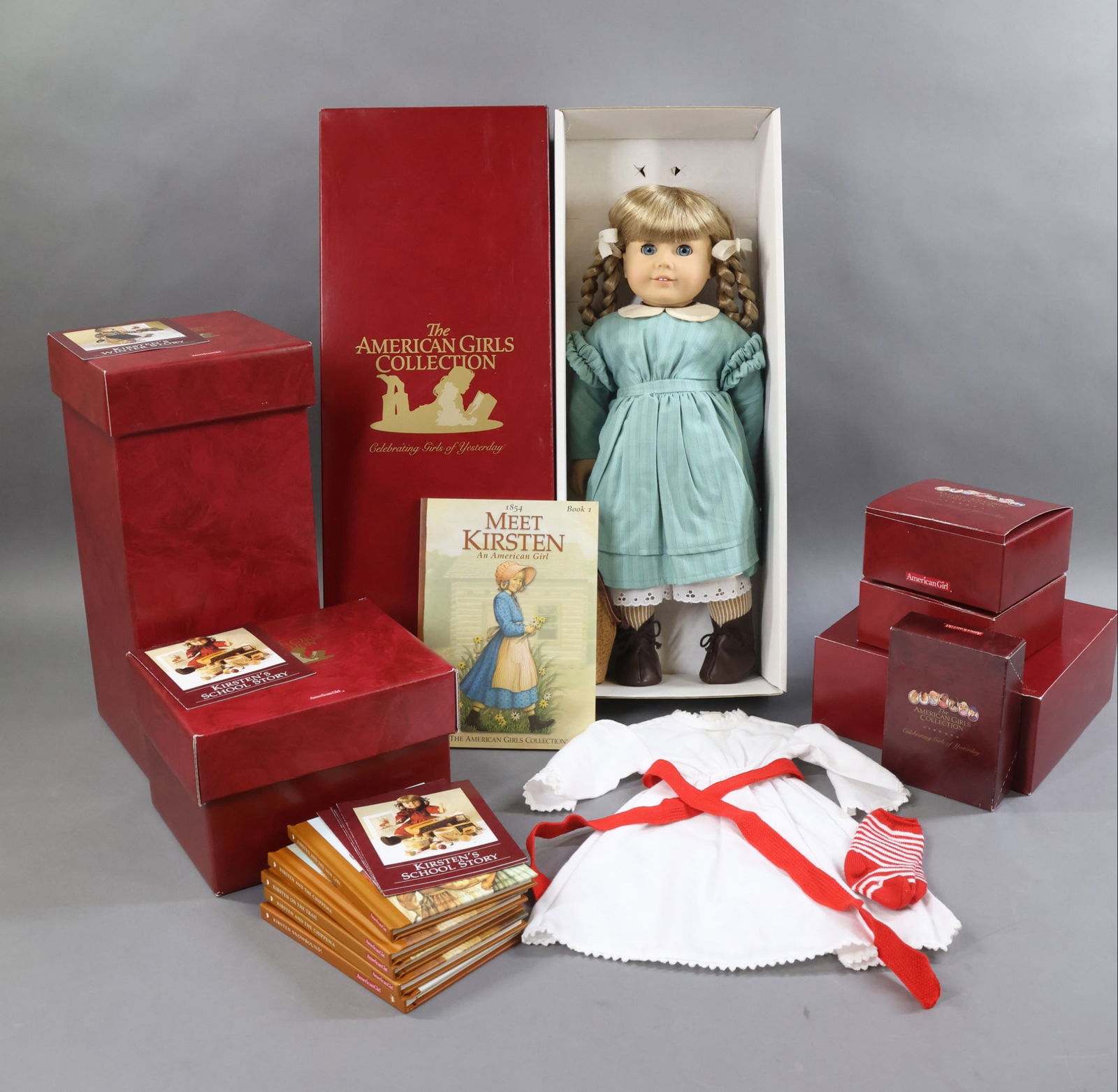 AMERICAN GIRLS.: LOT of KIRSTEN. Doll in OB w/book. Saint Lucia Gown, Wreath, Tray. School Bench. Wooden Chair. Mama Cat & Kitten. Pioneer School Lunch. (5) Short Stories Books. This lot is being sold AS IS.