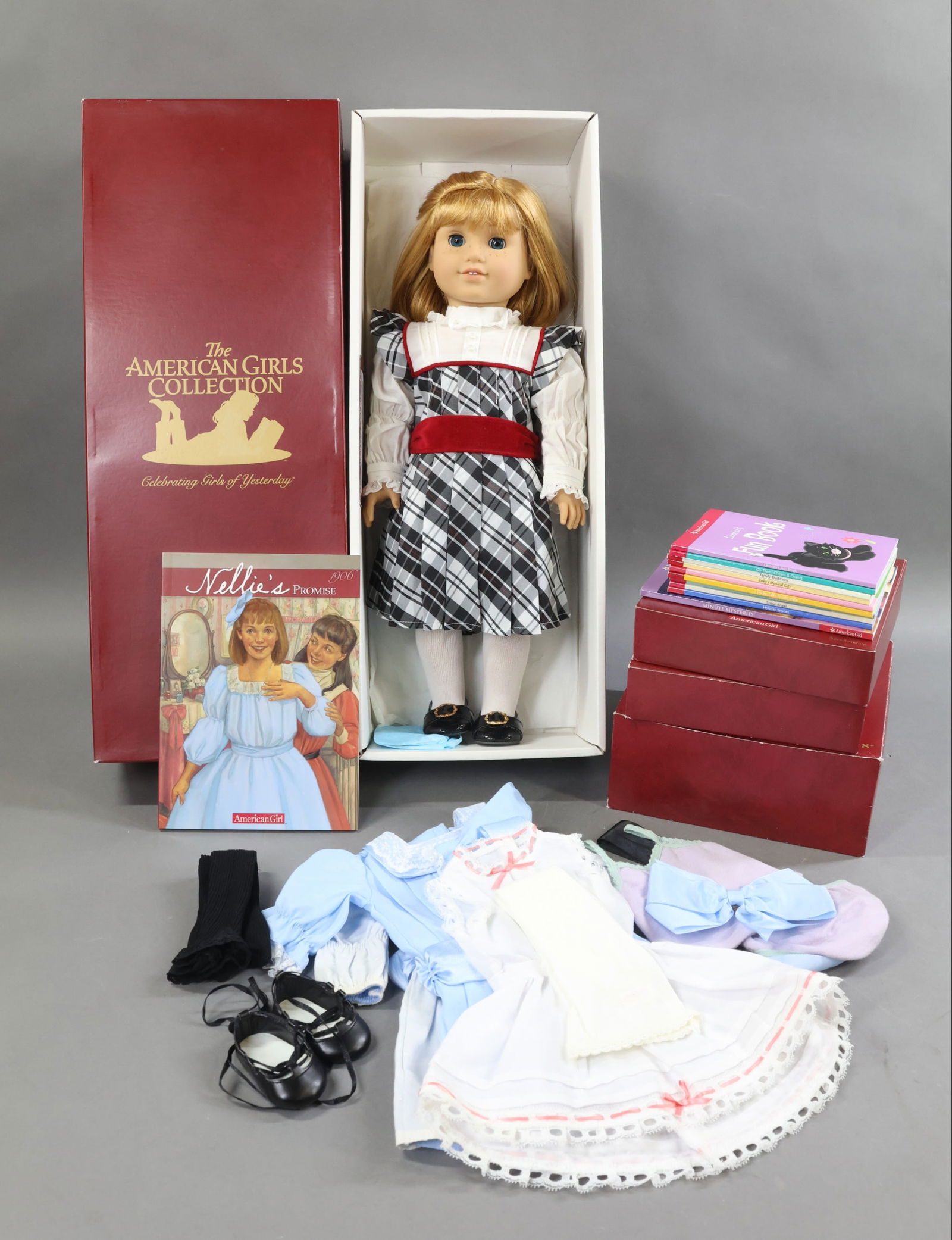 AMERICAN GIRLS.: LOT of NELLIE. Doll in OB w/book. (2) Nellie's Dolls Lydia. Misc. clothing. Lot of 9) misc. Books and Minute Mysteries Book. Condition: outfits may not be complete. This lot is being sold AS IS.