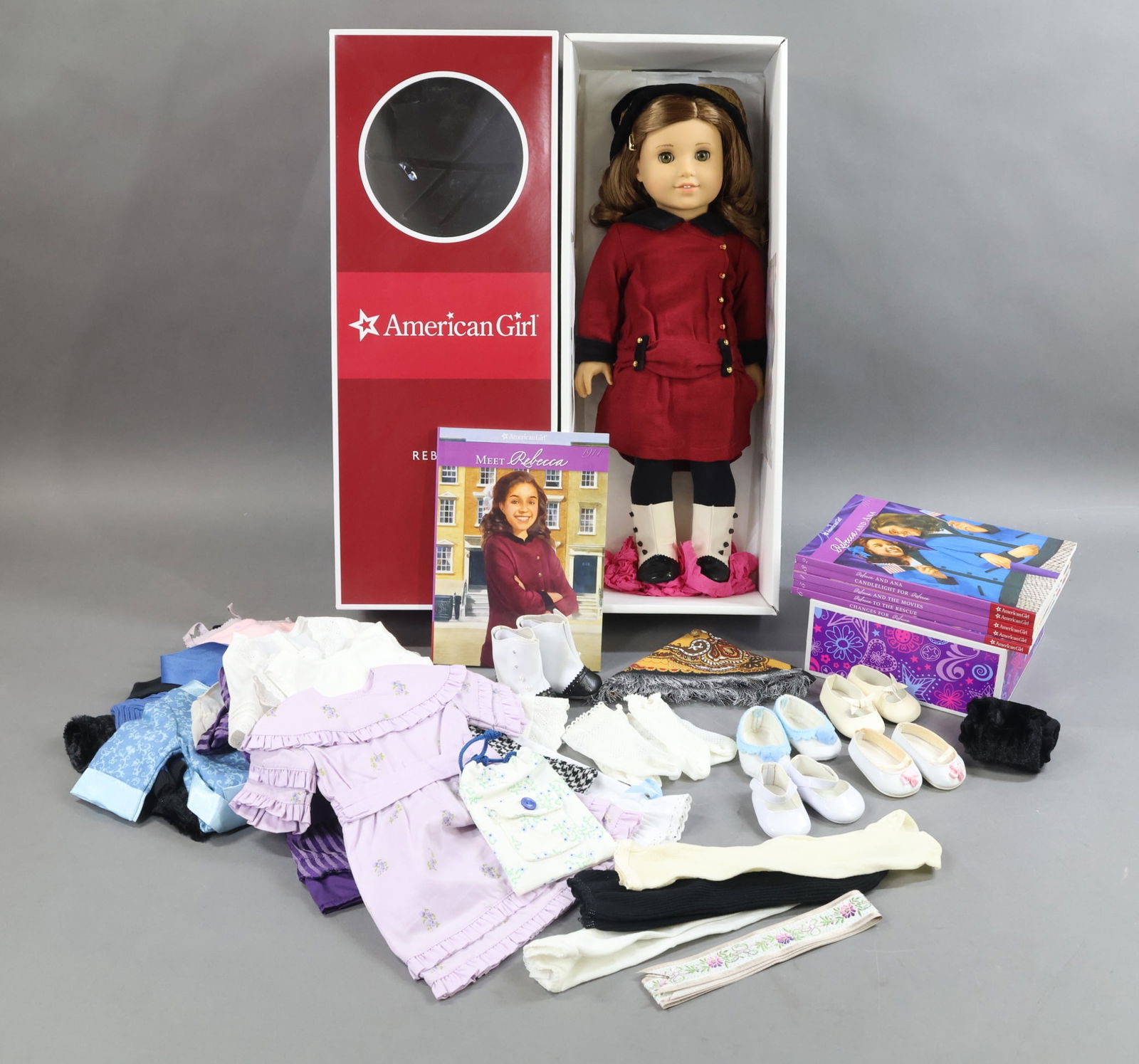 AMERICAN GIRLS.: LOT of REBECCA. Doll in OB w/book. Books 2, 3, 4, 5, 6. Suitcase full of Clothing, Accessories. Condition: outfits may not be complete. This lot is being sold AS IS.