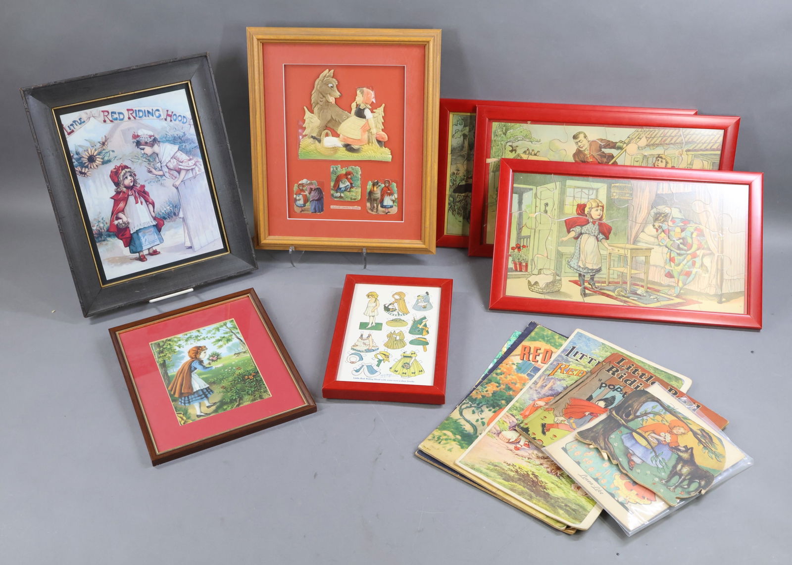 HOLIDAY/NOVELTIES.: LOT of antique Red Riding Hood items. Professionally FRAMED - (3) Jigsaw Puzzle pictures. 10 1/2" x 17 1/4". "Little Red Riding Hood with some now-a-days frocks" paper doll drawn by M.G. Hays. From