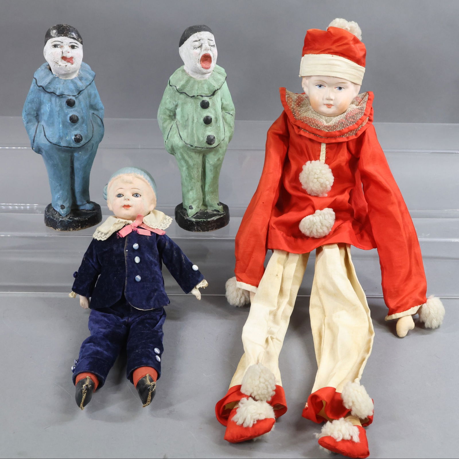 PAPIER MACHE DOLLS.: LOT of (4) character dolls/figures. Doll 1) 13" Unmarked shoulder head with stationary glass eyes, molded painted hair and hat. Cloth body with papier mache lower arms. Dressed in antique velvet 2 pc.