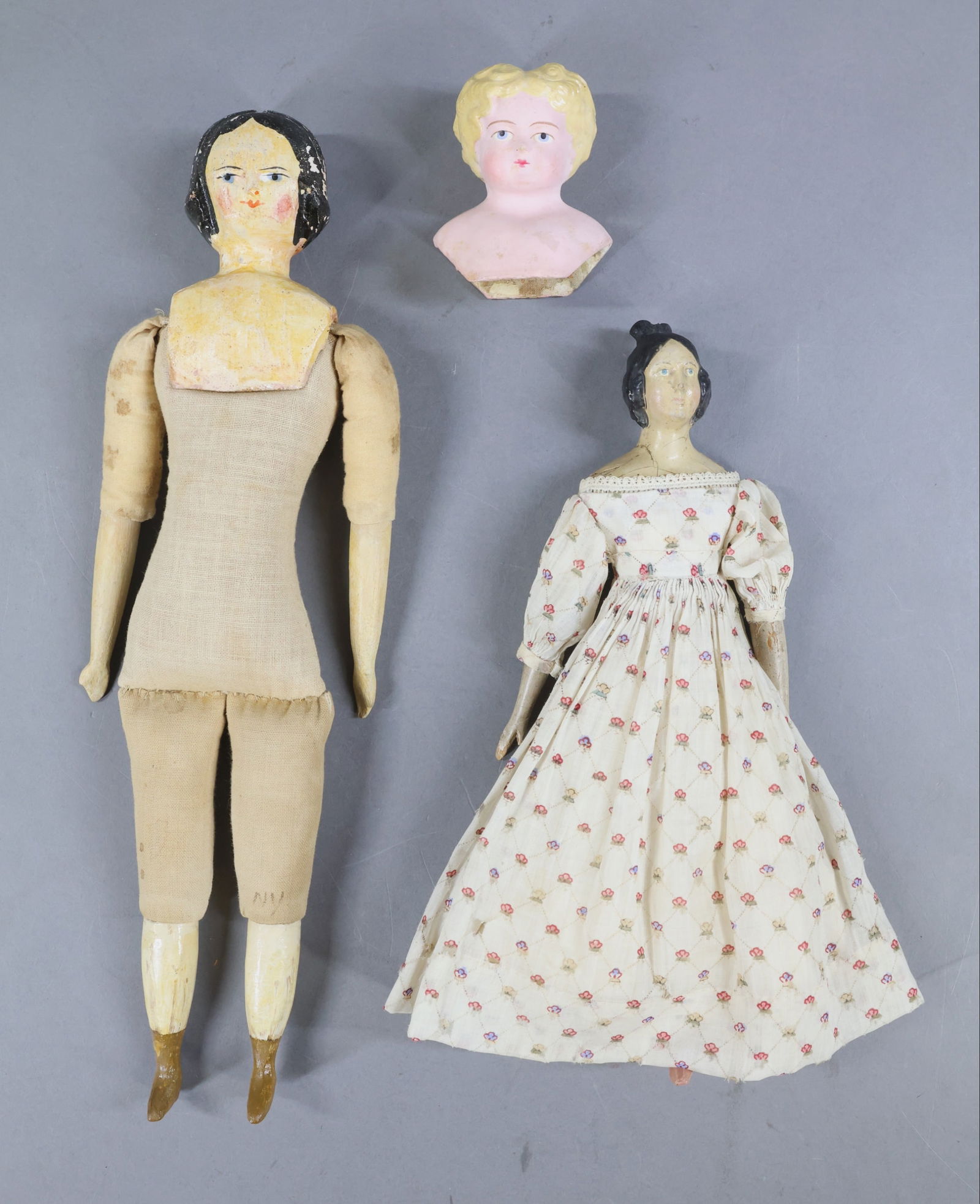 PAPIER MACHE/OTHER DOLLS.: LOT. Papier mache -Doll 1) 11"Unmarked Milliners Model doll with Apollo Knot/type black hair style. Blue eyes. Leather body with wooden lower arms and legs, painted pink boots. Dressed in antique