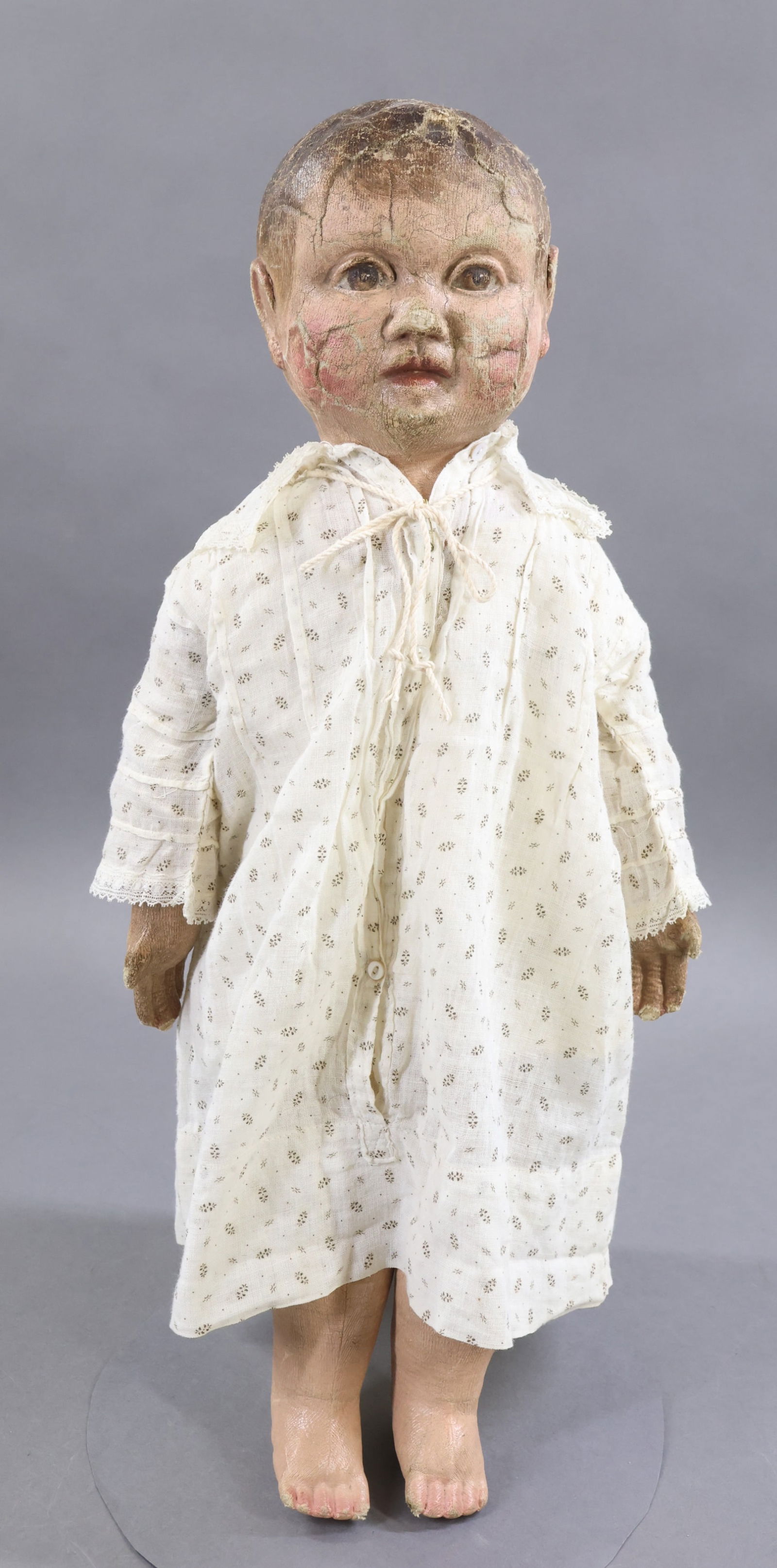 CLOTH DOLLS.: 21" Unmarked "PHILADELPHIA BABY" style doll with stockinette body, oil painted features and hair. c. 1900. These dolls are known for their well modeled facial features, especially around the eyes, ear