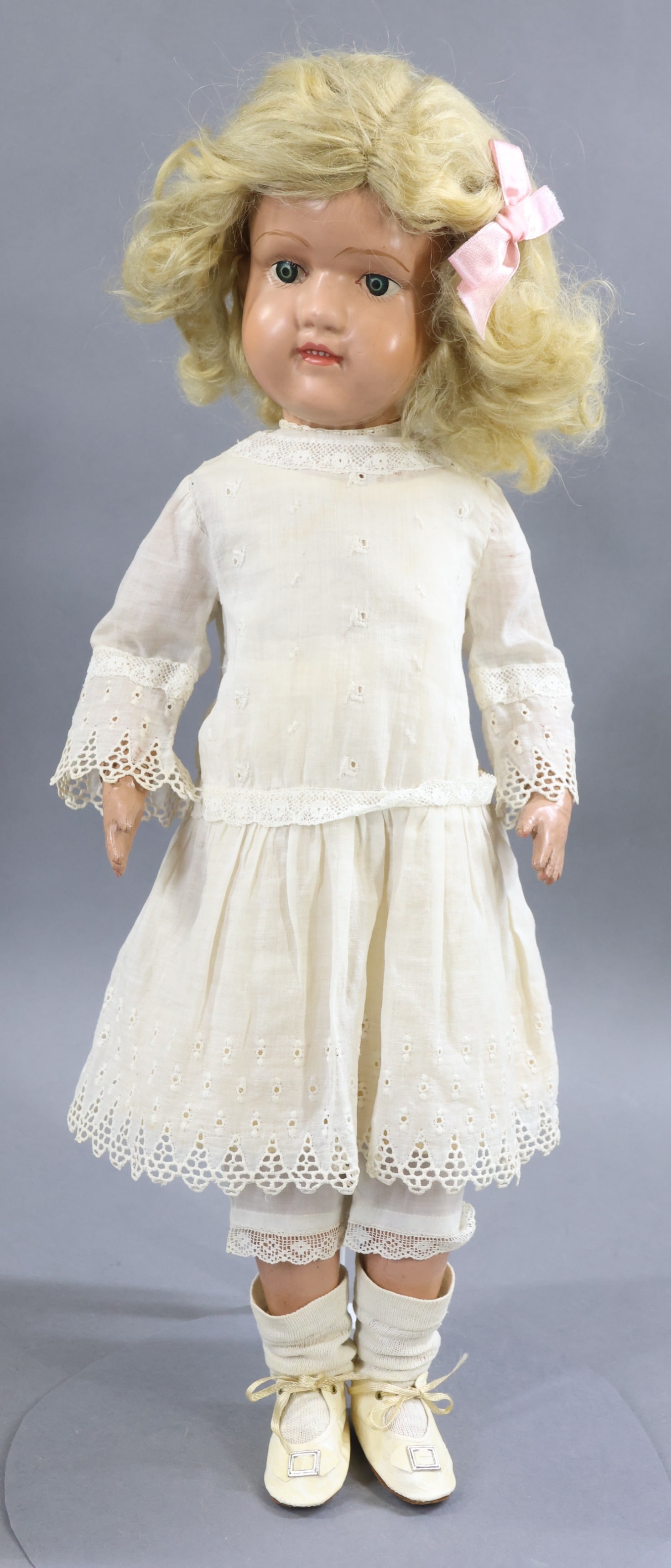 SCHOENHUT.: 19" Model No. 316 "Miss Dolly", 1920-1924. Blue decal eyes. Open/closed mouth with (4) painted teeth. Original blonde mohair wig. Marked with oval decal on back. No original clothing, she is dressed