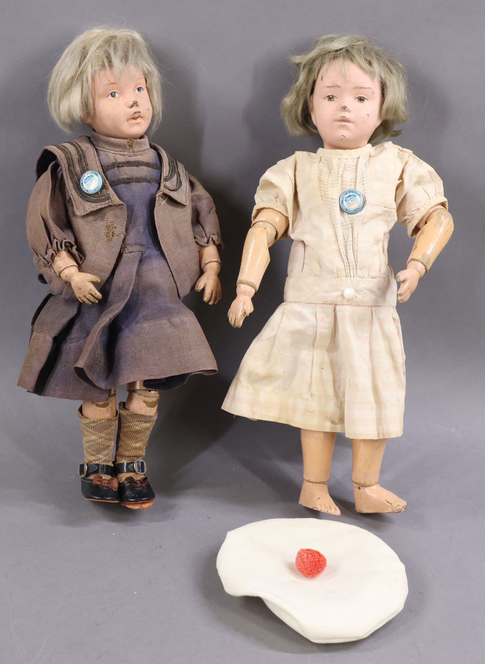 SCHOENHUT.: Pair of dolls. Both dolls have mohair wigs, intaglio eyes and have the incised marks on the back of their torsos. Doll 1) 14" Model No. 312, 1912-1924. Brown eyes, original tosca wig. Union suit may