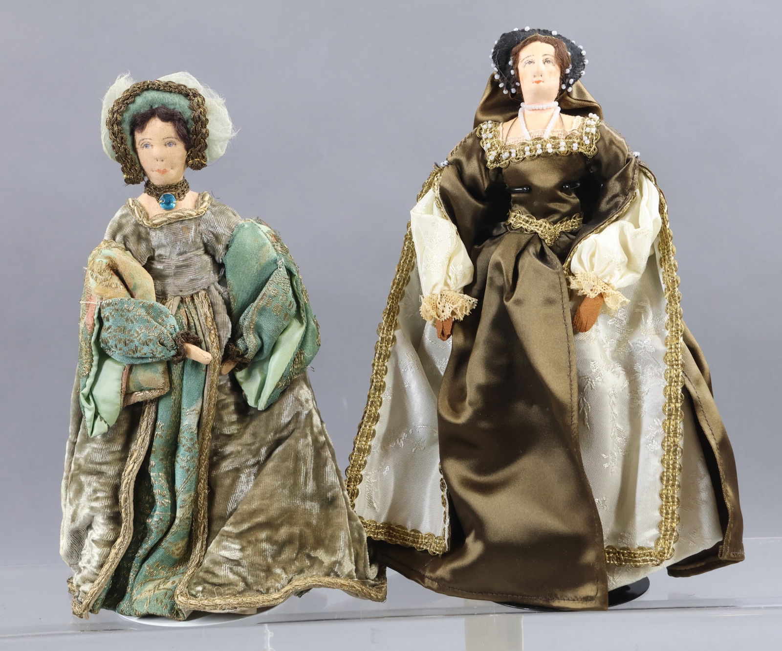 LIBERTY OF LONDON.: Pair of tagged "Anne Boleyn" dolls - 2nd wife of King Henry VIII. She was beheaded as she produced no male heir. She was the mother of Queen Elizabeth I. They are dressed in different outfits. (2) Sta