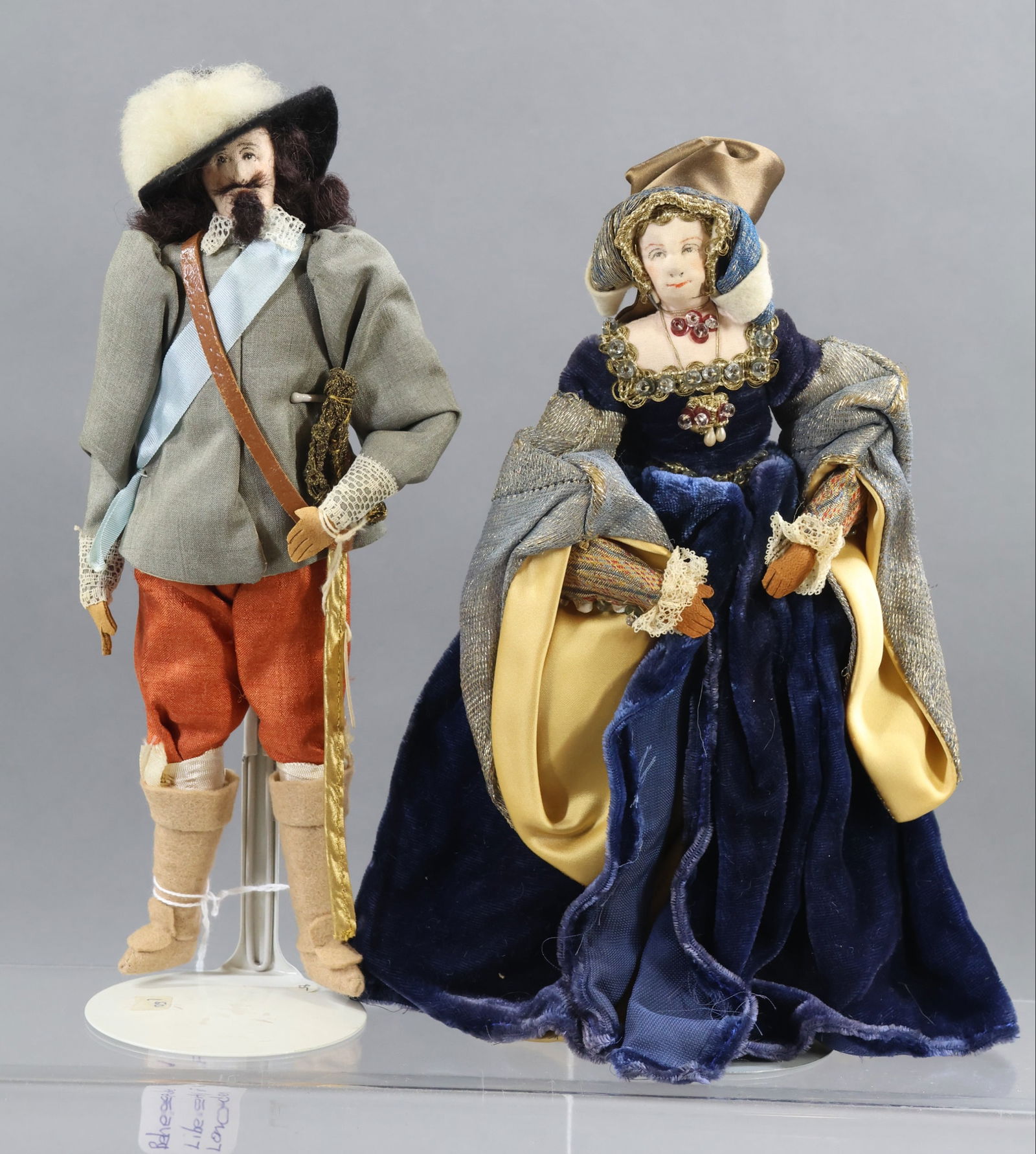 LIBERTY OF LONDON.: Pair of tagged dolls. "Jane Seymour" with both the blue hang tag and cloth tag. Wife of Henry VIII. Also - "Charles I", ruled England 1626-1649. Cloth tag. (2) Stands. Condition: age discoloration. Th