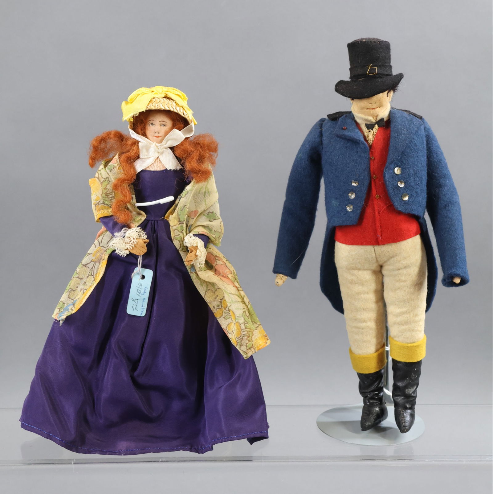 LIBERTY OF LONDON.: Pair of tagged dolls. "Lady Hamilton" with blue hang tag and cloth tag. "John Bull" with cloth tag. (2) Stands. Condition: age discoloration. This lot is being sold AS IS.