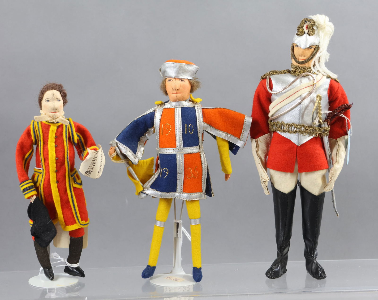 LIBERTY OF LONDON.: LOT of (3) male dolls. 7" Unmarked "Choir Boy" from the 1937 Coronation. Hang tag reads "Chorister". 7 1/2" Tagged very rare "Herald" to Commemorate the Silver Jubilee of George V. Tunic reads 19 10 -