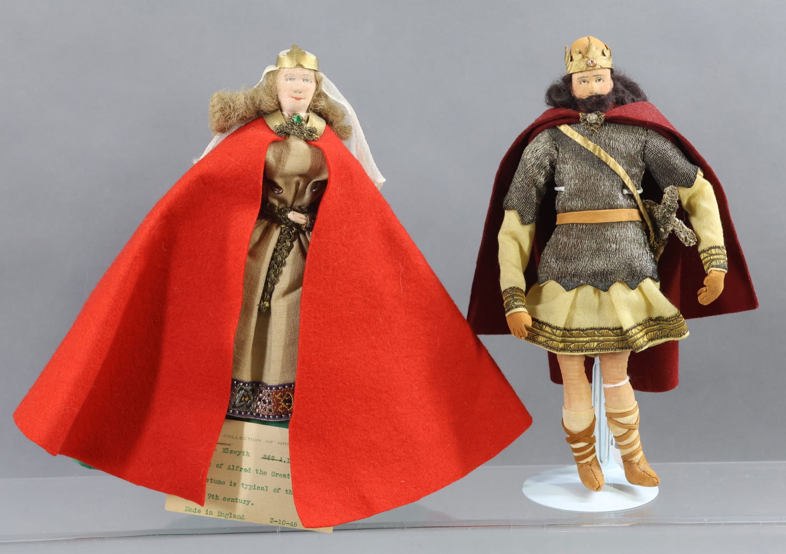 LIBERTY OF LONDON.: Pair of tagged dolls. "King Arthur" . "Elswyth". Her tag reads: 868 A.D. Consort of Alfred the Great (848-901) Her costume is typical of those worn in the 9th century. Condition: minor moth holes on b