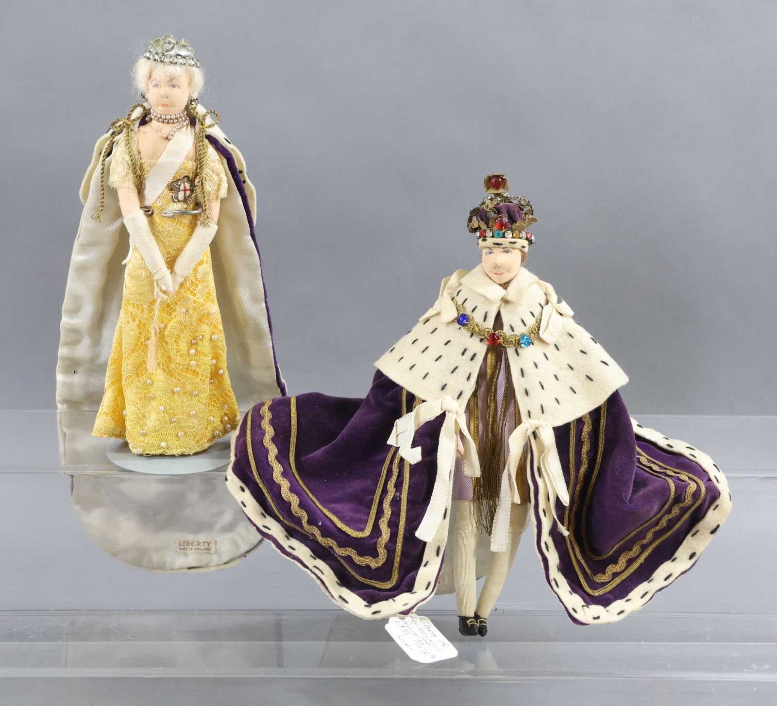 LIBERTY OF LONDON.: Pair of tagged dolls. "King George VI" 1936-1952. He was crowned May 12, 1937. "Queen Mother". (1) Stand. Condition: age discoloration, minor loss. This lot is being sold AS IS.