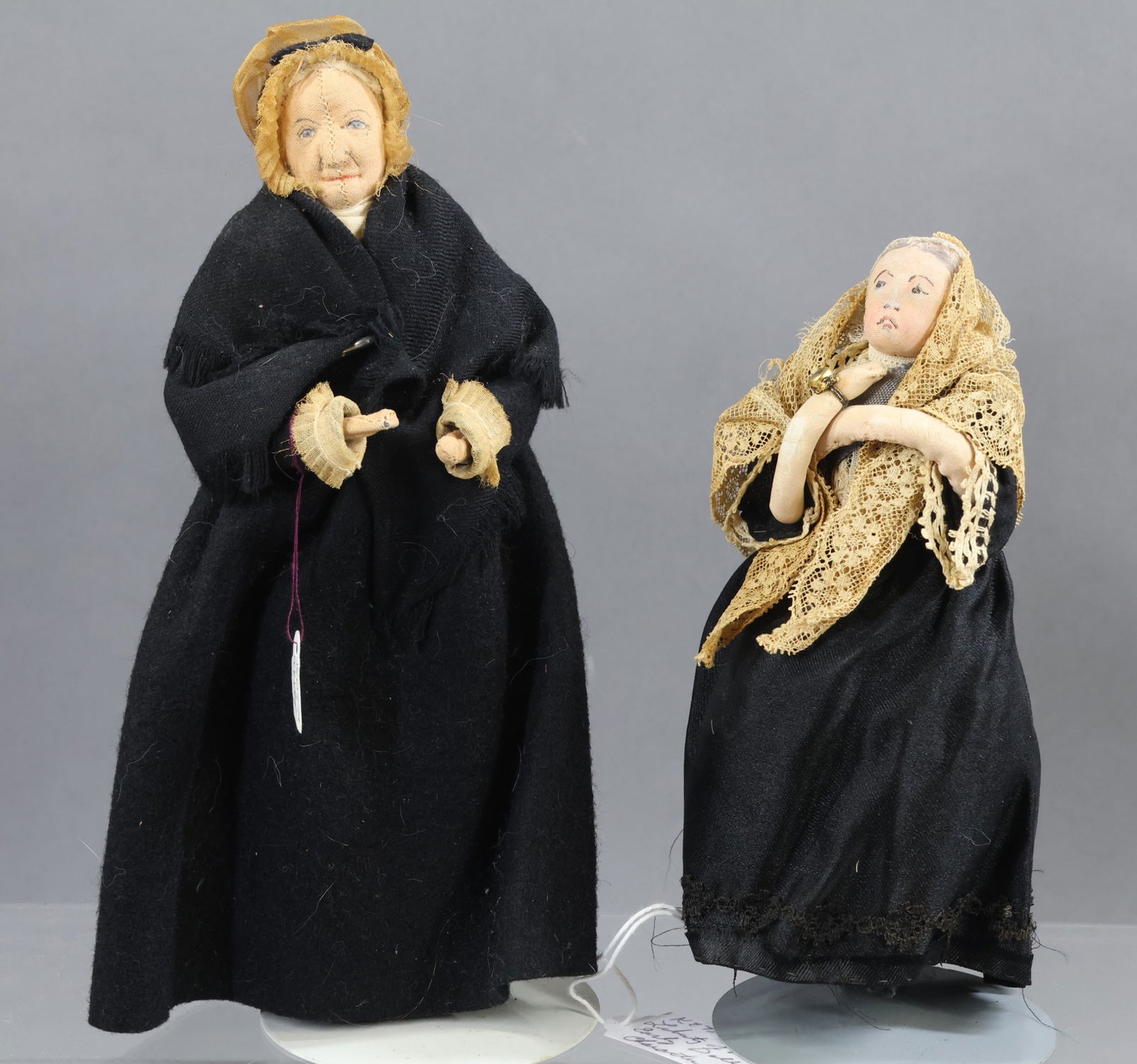 LIBERTY OF LONDON.: Pair of female dolls. 6 1/2" Unmarked early "Character Lady" doll. 9" Tagged "Susanna Wesley - Mother of Methodism". Center seam. (2) Stands. Condition: age loss on 6 1/2" doll. This lot is being sold