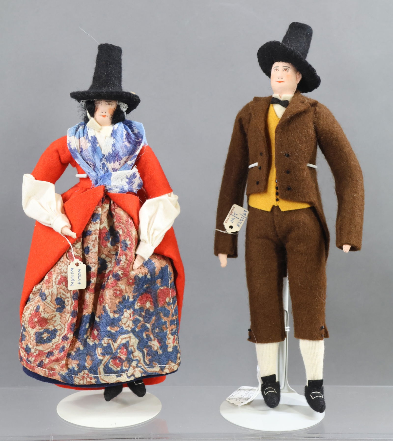 LIBERTY OF LONDON.: Pair of tagged dolls. "Welsh Woman". "Welsh Man". (2) Stands. Condition: nothing observed. This lot is being sold AS IS.