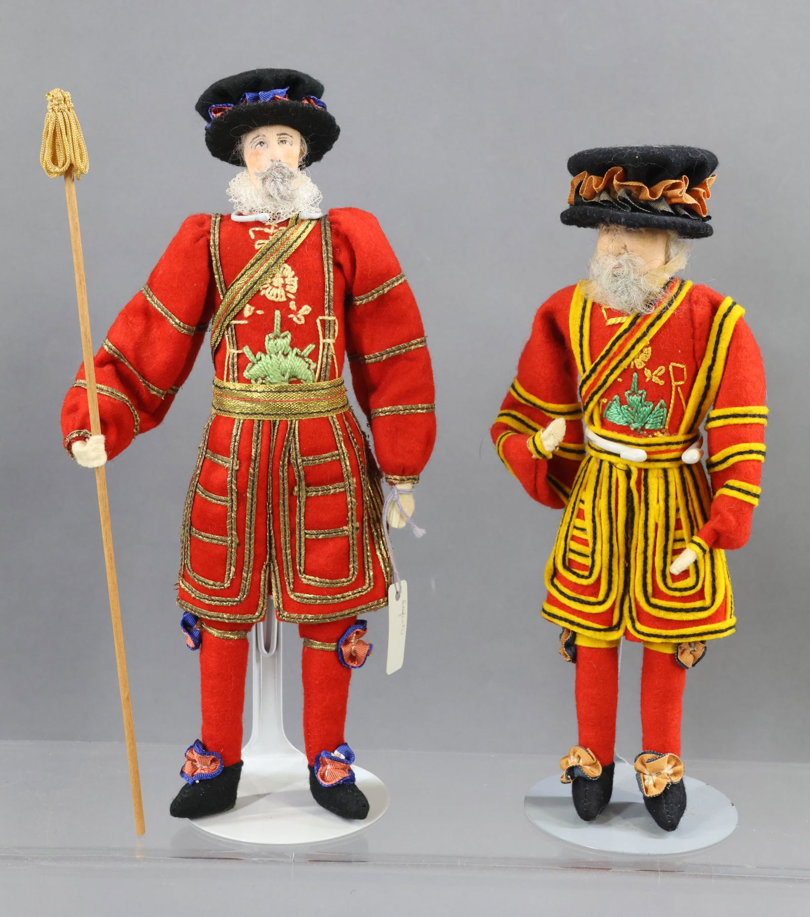 LIBERTY OF LONDON.: Pair of tagged male dolls. 9" "Yeoman Warden of The Tower". 10" "Beefeater". Center seam. (2) Stands. Condition: nothing observed. This lot is being sold AS Is.