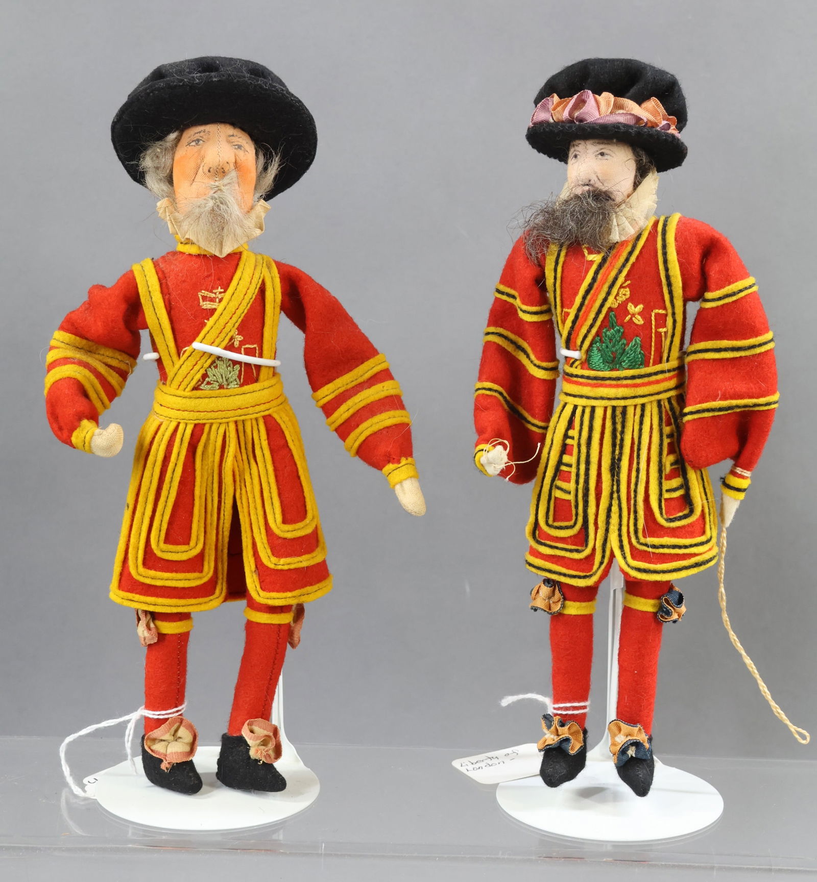 LIBERTY OF LONDON.: Pair of male dolls. Tagged "Yeoman of the Guard", 1937 King George VI. Unmarked "Yeoman Warden of the Tower", 1937. Condition: moth hole on (1) sleeve of this doll. Both dolls have center seams. (2) S