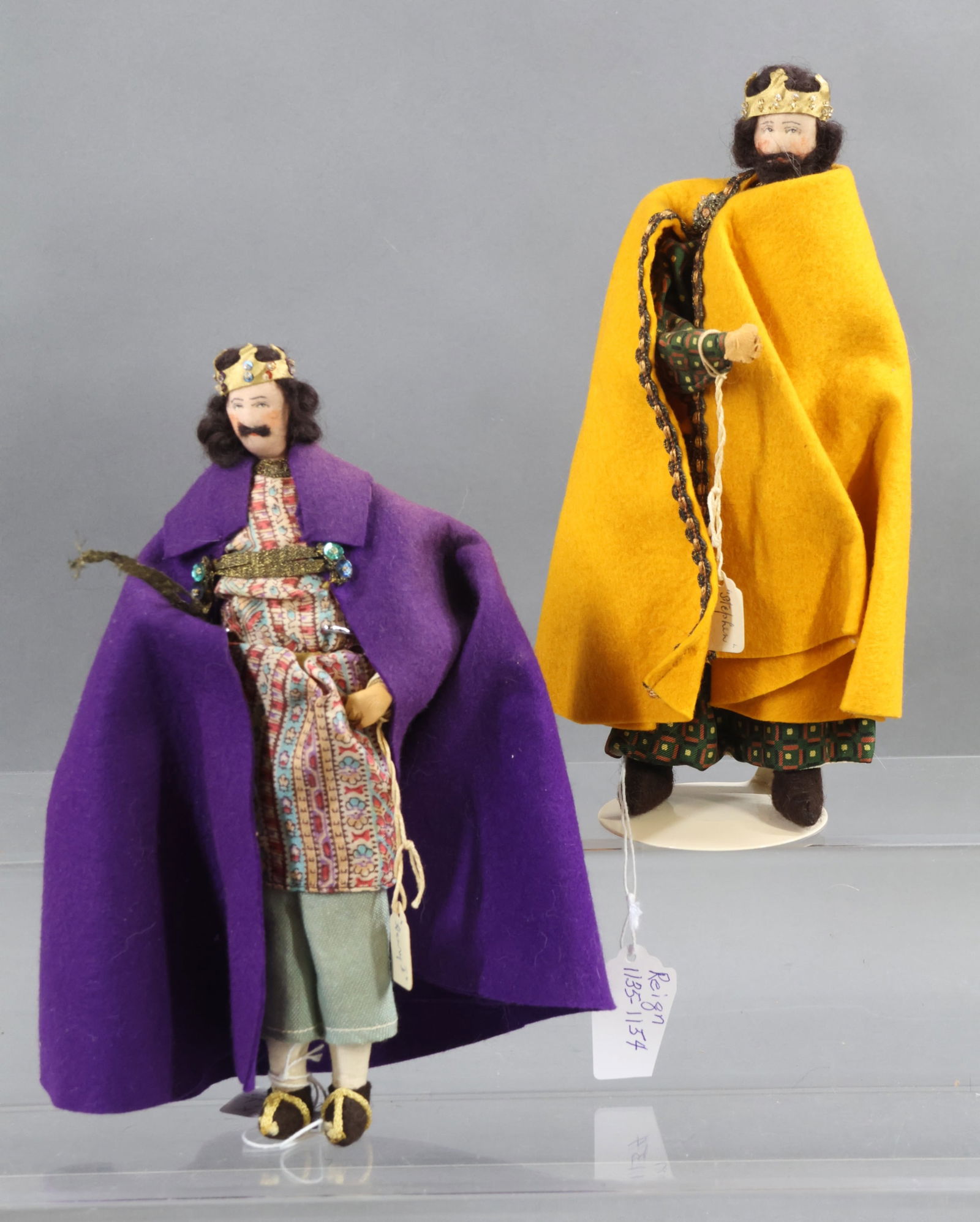 LIBERTY OF LONDON.: Pair of tagged male dolls. "Henry I", Reign was 1100-1135. "Stephen", Reign was 1135-1154. (1) Stand. Condition: minor age fading. This lot is being sold AS IS.