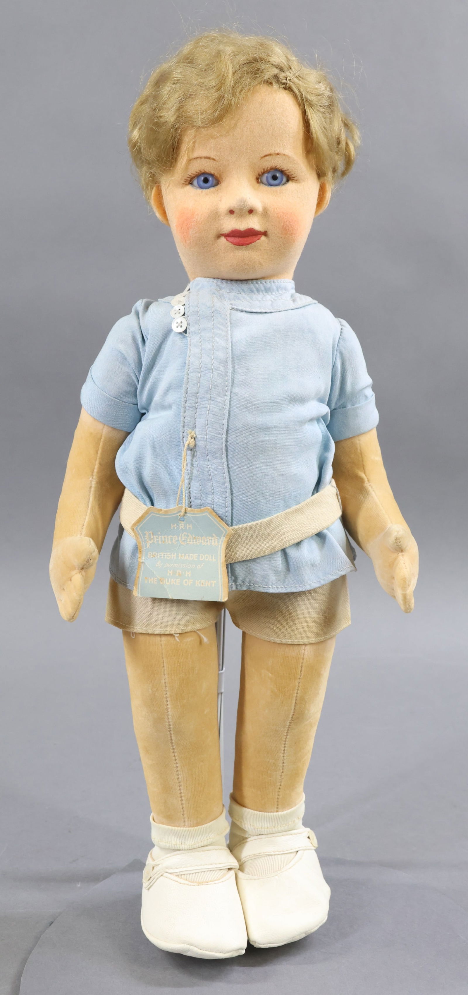 ROYAL DOLLS.: 15" Tagged "H.R.H. Prince Edward", ca. 1938. Made by CHAD VALLEY. All original doll with hang tag. Molded felt head with stationary blue glass eyes, dark honey blonde mohair wig. Velveteen body with s
