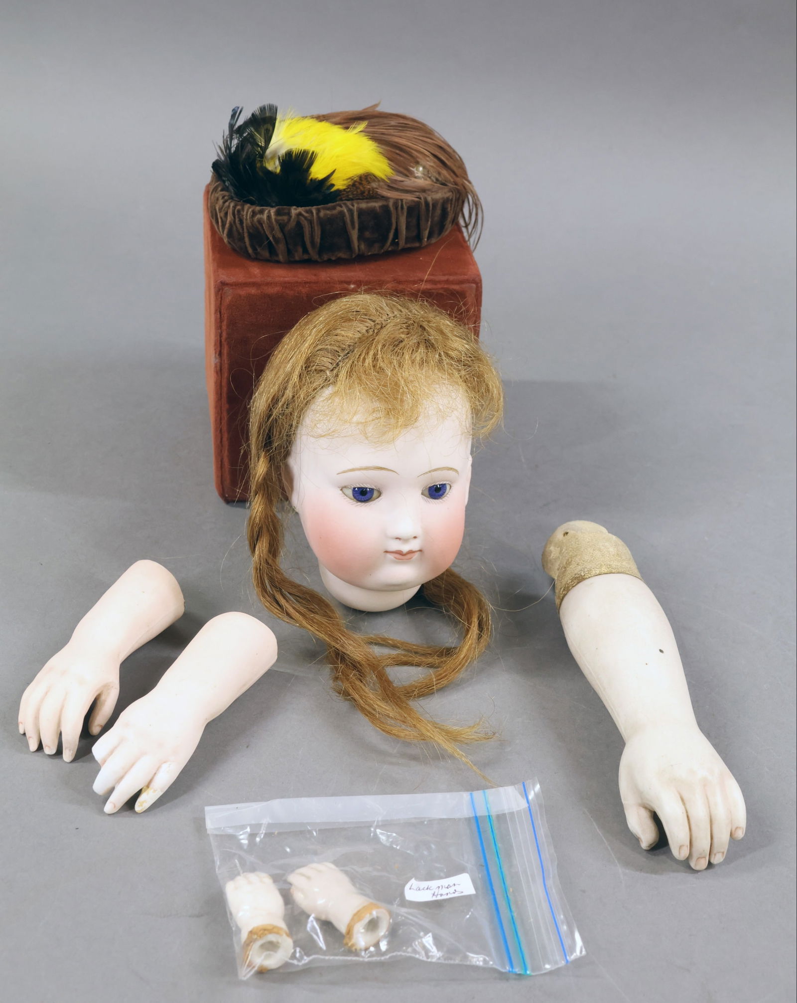 ANTIQUE/FRENCH BODY PARTS.: LOT of antique parts. Beautiful unmarked French Fashion doll head. 4 1/2" t X 9 1/2" circ. Blue paperweight eyes, cork pate, brown HH wig, pierced ears. Condition: hairline from rim edge down over