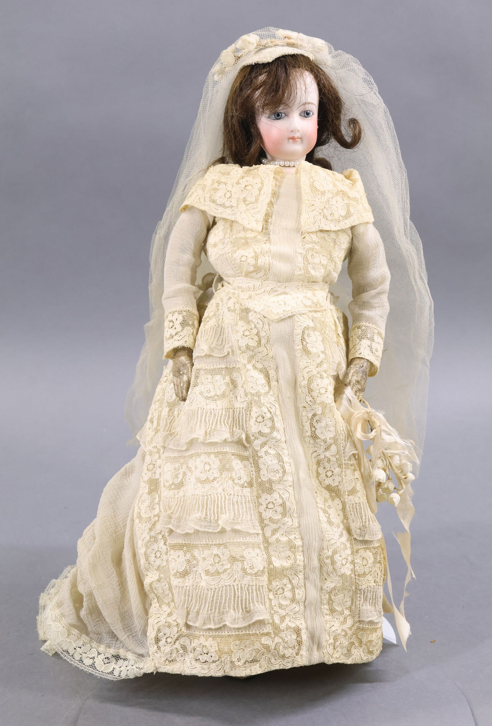 ANTIQUE FRENCH BISQUE HEAD DOLL.: 14" "1" (F G?) French Fashion Doll. Blue paperweight eyes, closed mouth, pierced ears, dark brown HH wig, cork pate. Socket head on a bisque shoulder plate. White leather gusseted body. Hands have ind